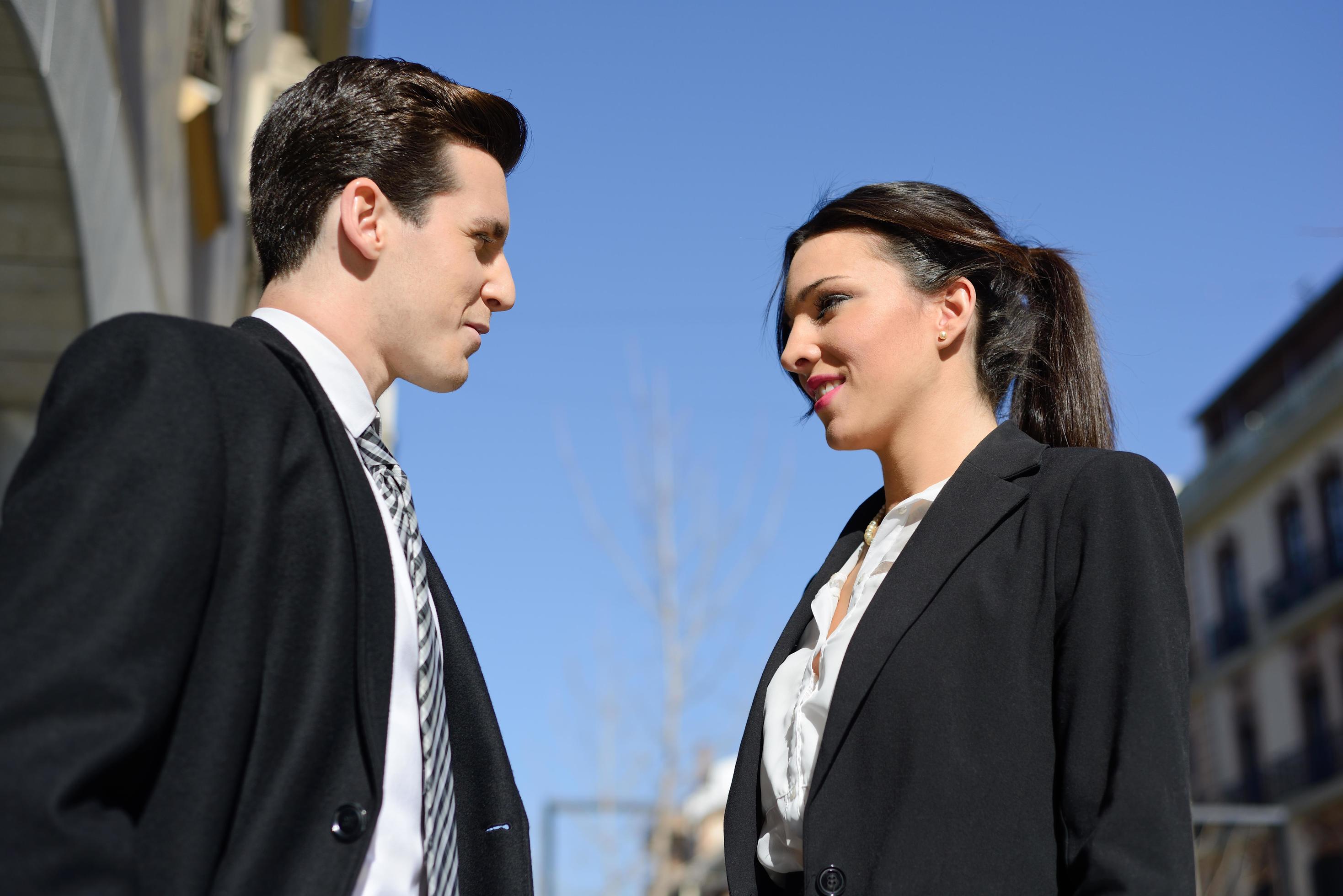 Business people talking outside of company building. Couple working Stock Free