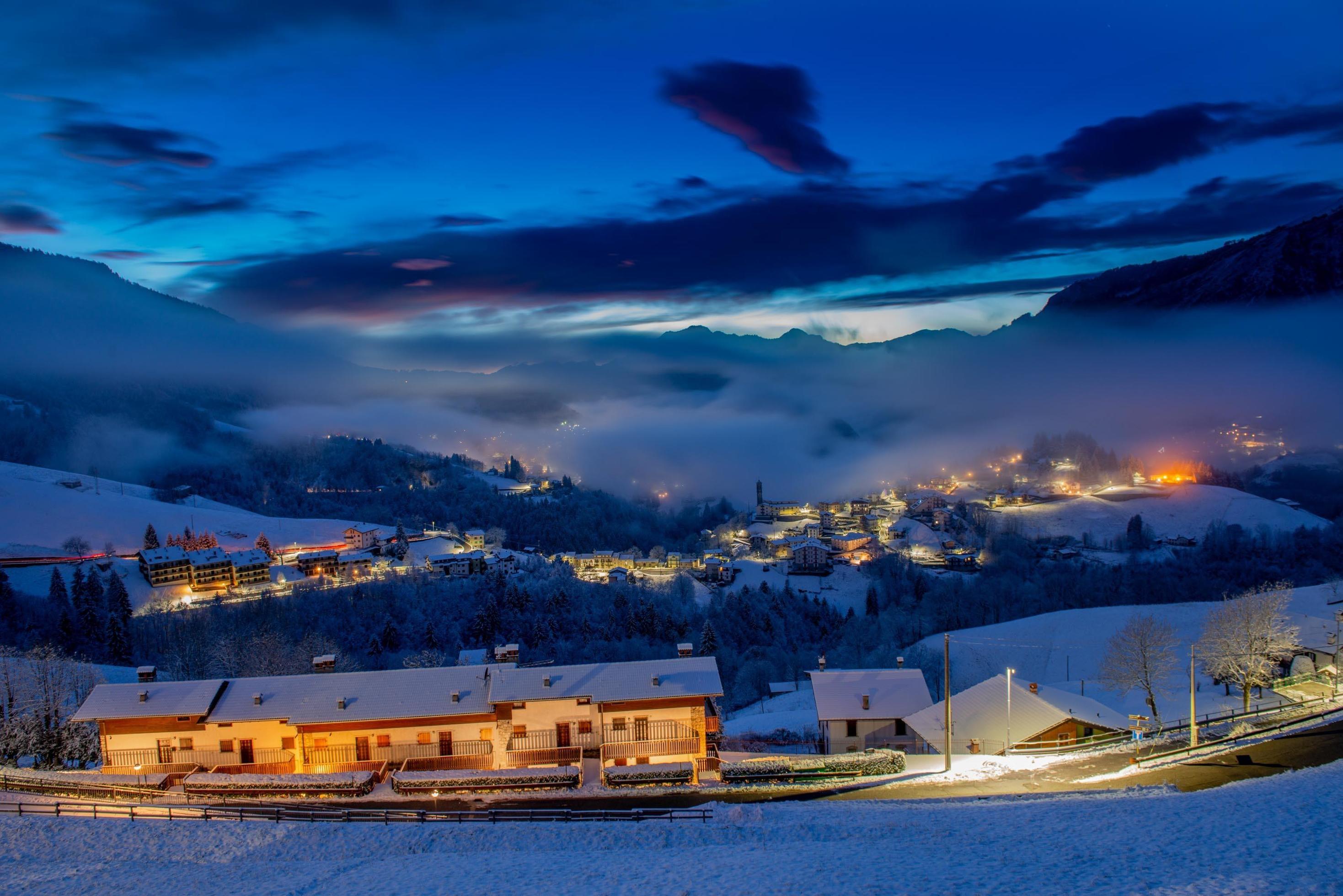 Snowy mountain village at sunset Stock Free