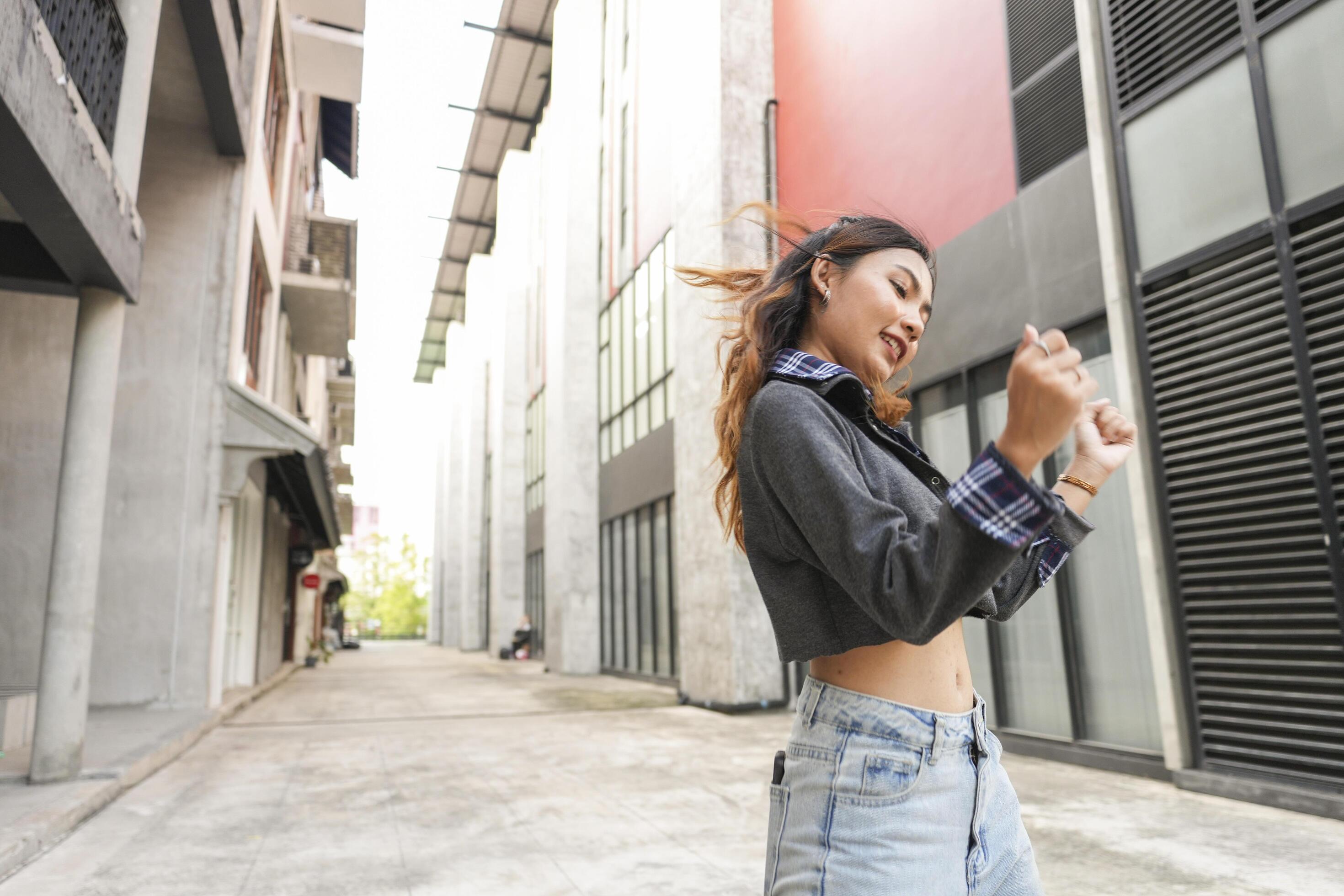 Asian women do freestyle hip hop and breakdancing in a public space in the middle of the city. With a cheerful and happy attitude Stock Free