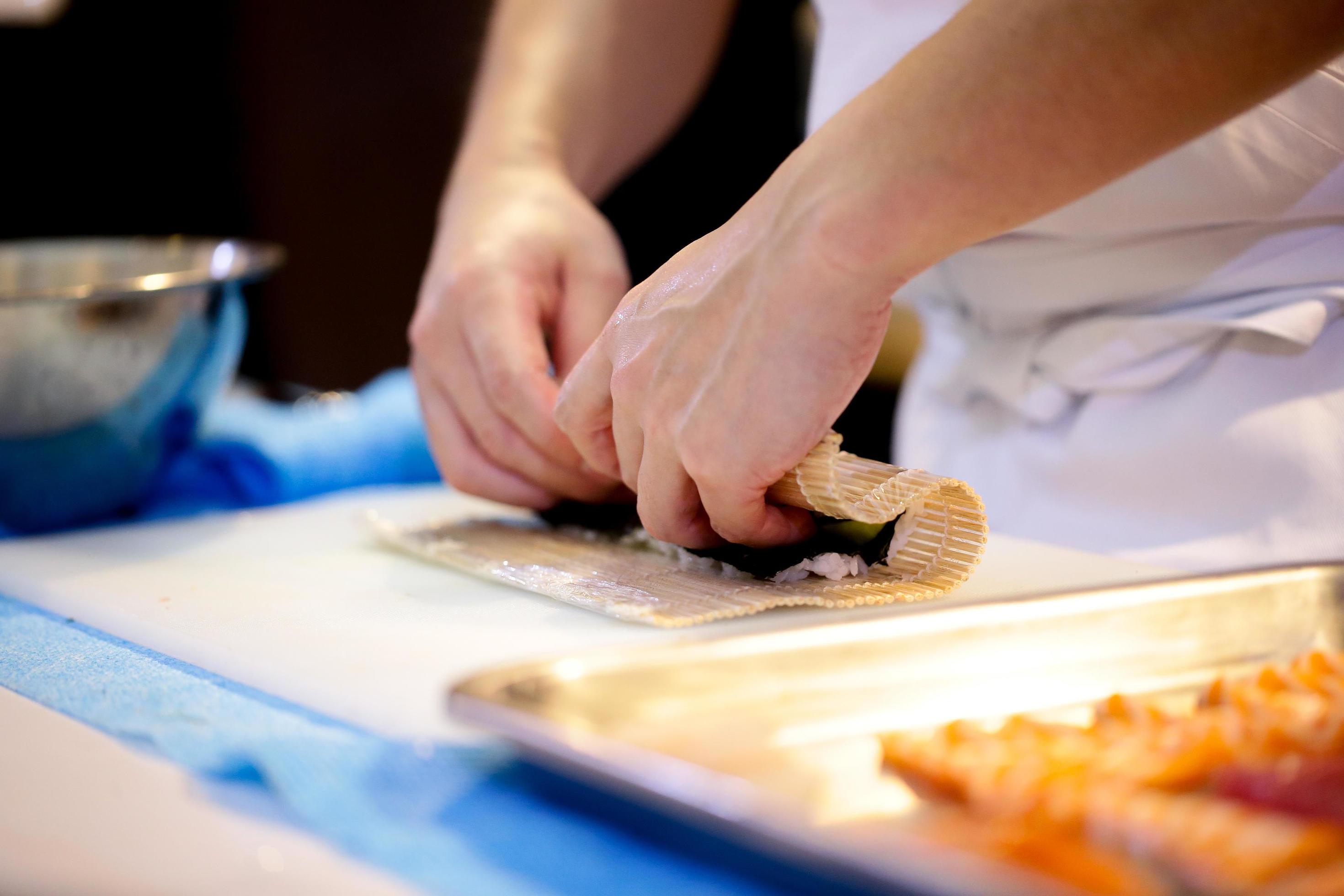 chef hands preparing japanese food, chef making sushi Stock Free