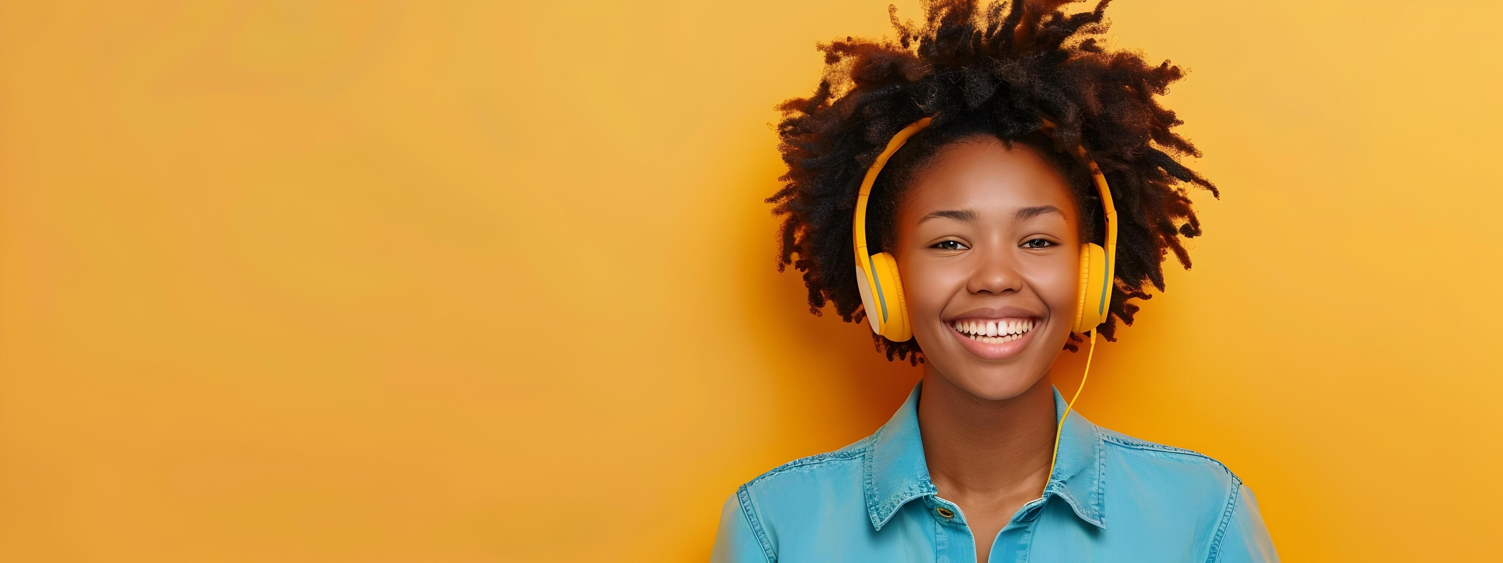 Cheerful Young African Woman with Headphones Smiling Happily Stock Free