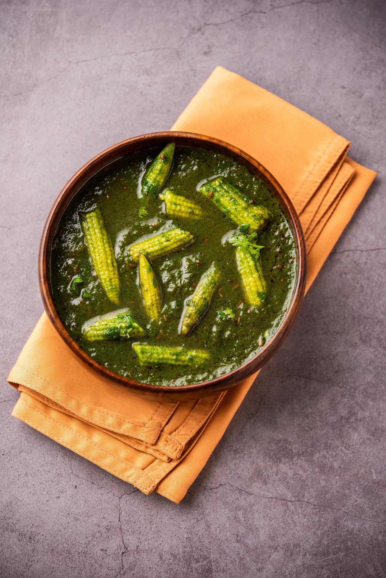 palak baby corn sabzi also known as spinach makai curry served with rice or roti, Indian food Stock Free