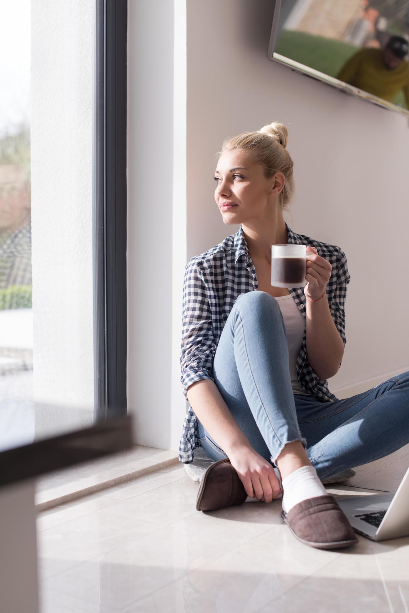 young woman drinking coffee enjoying relaxing lifestyle Stock Free