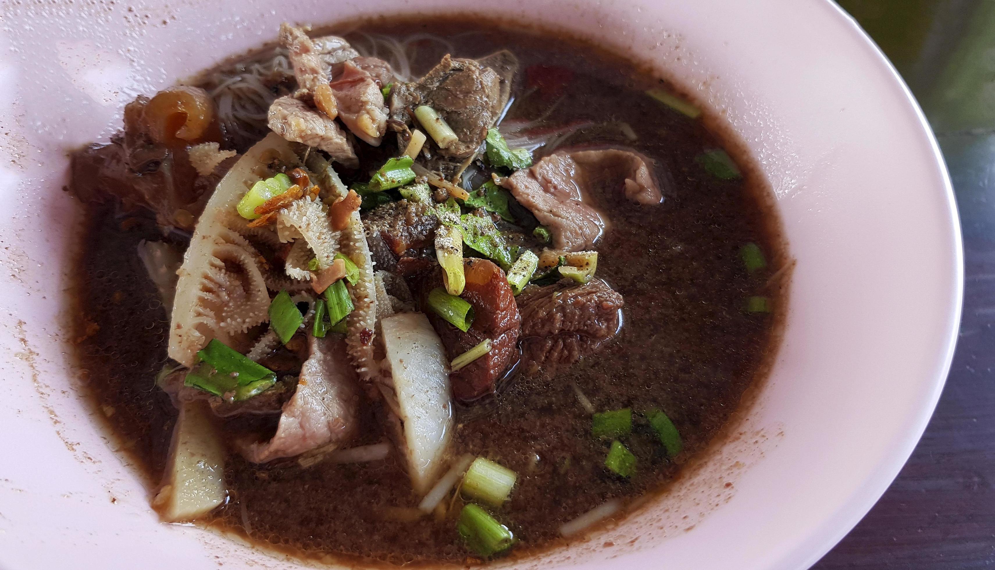 Close up Thai noodle with, pork or beef liver and blood soup on pink bowl. Asian and famous food in Thailand. Stock Free