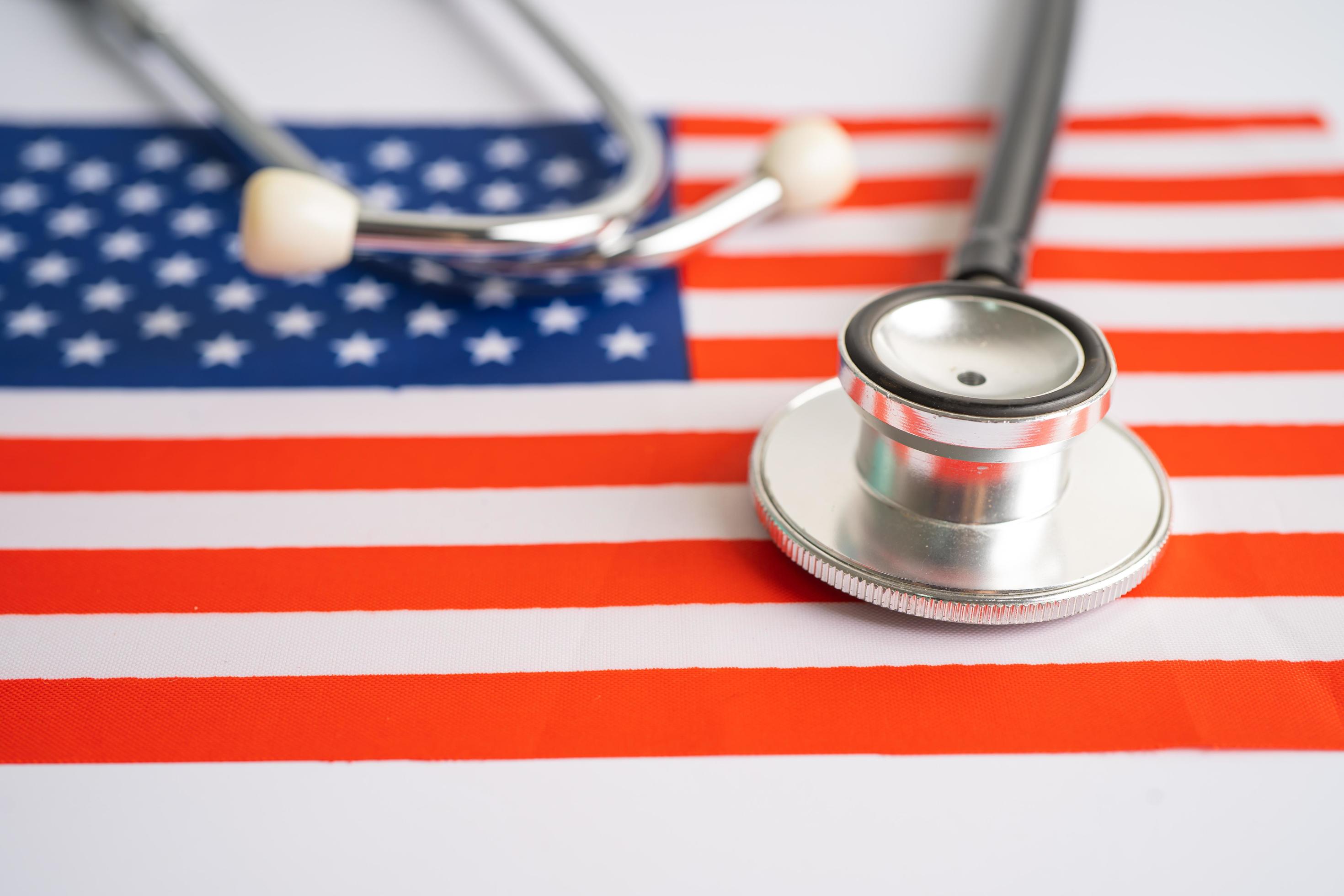 Black stethoscope on USA America flag background, Business and finance concept. Stock Free