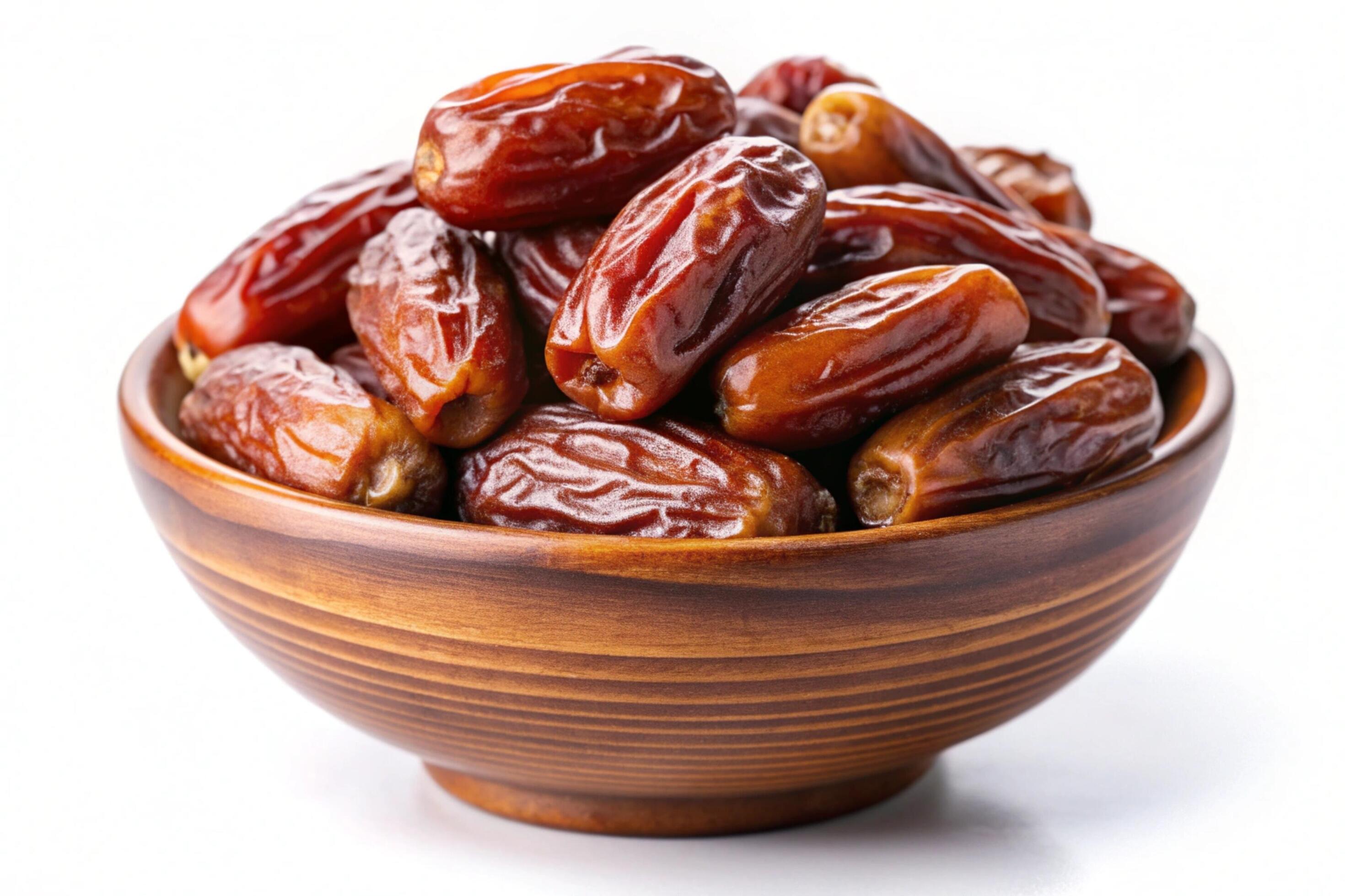 Dates in wood bowl isolated on white background Stock Free