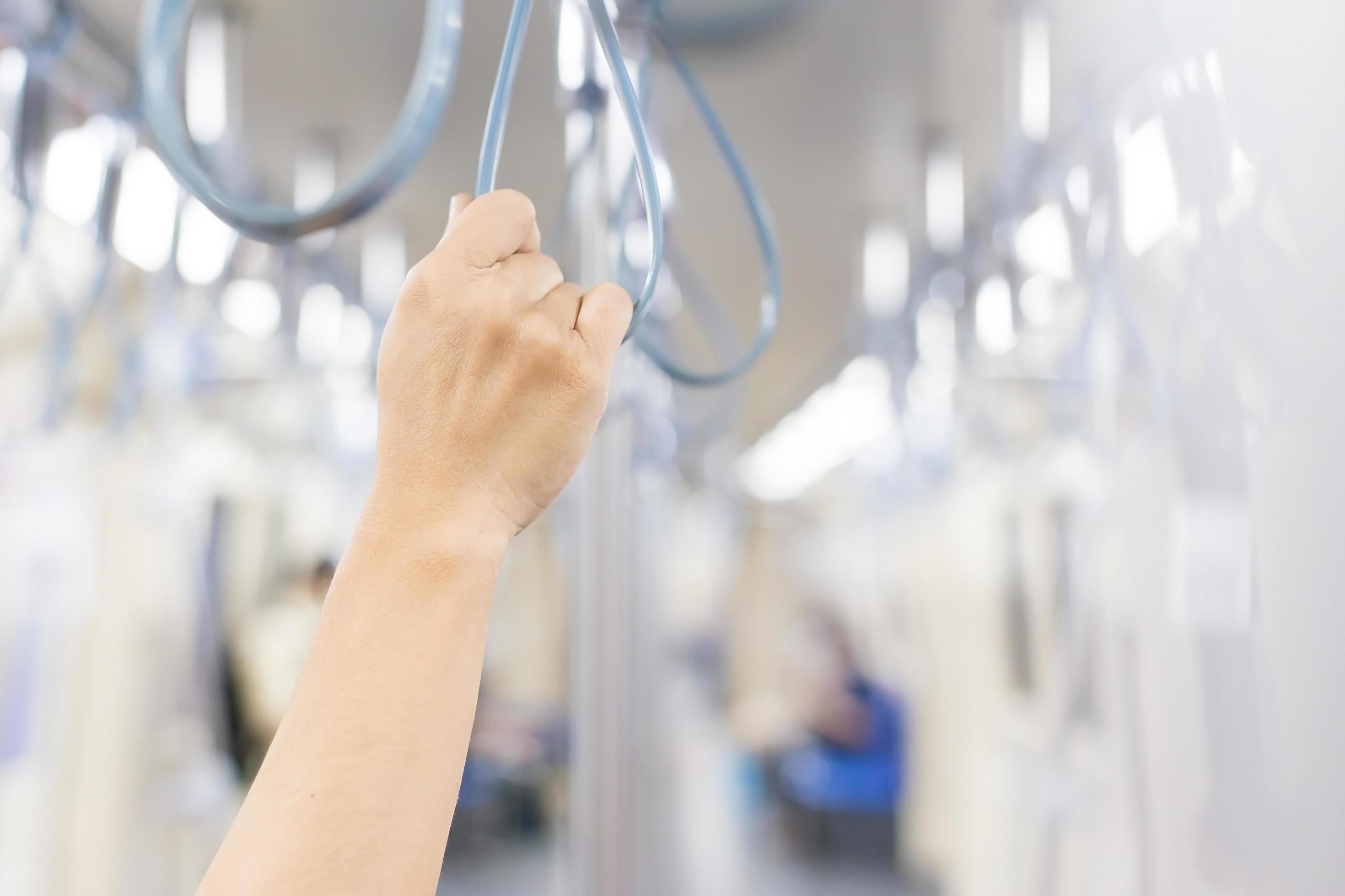 Passenger’s hand was holding a looped handle at the urban public transportation in a subway or metro in a big city as work lifestyle concept. Stock Free