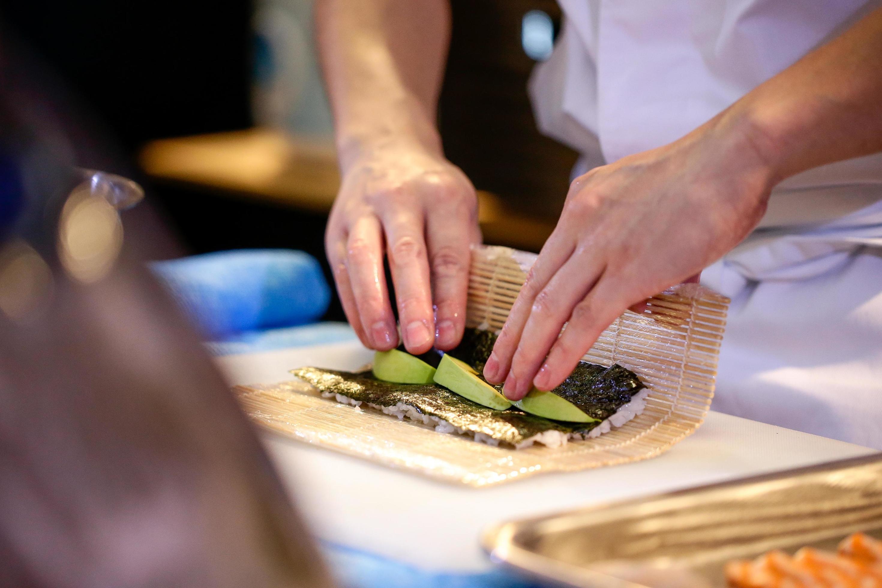 chef hands preparing japanese food, chef making sushi Stock Free