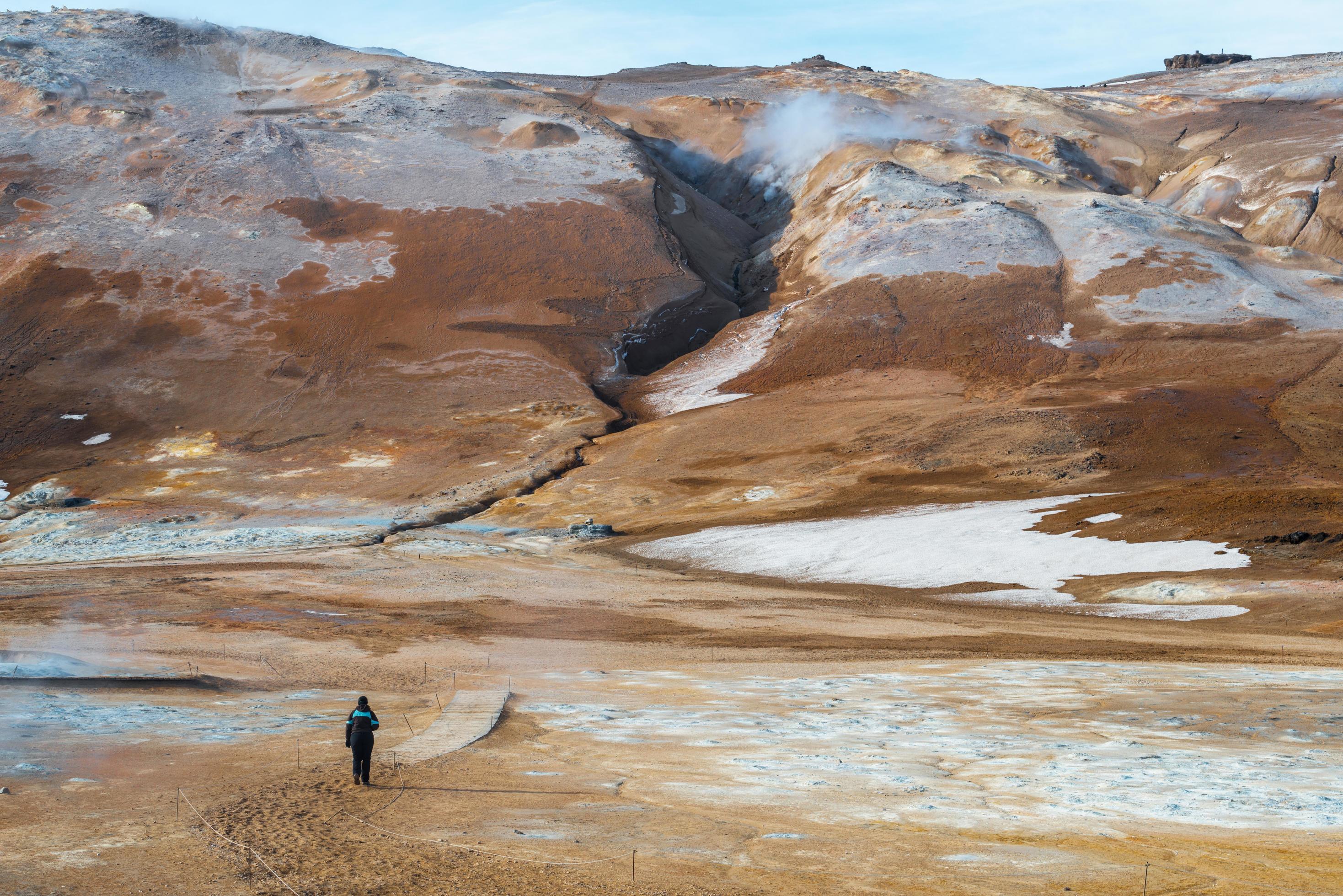 Tourist walking on the landscape of geothermal area of Northeast Iceland. Stock Free