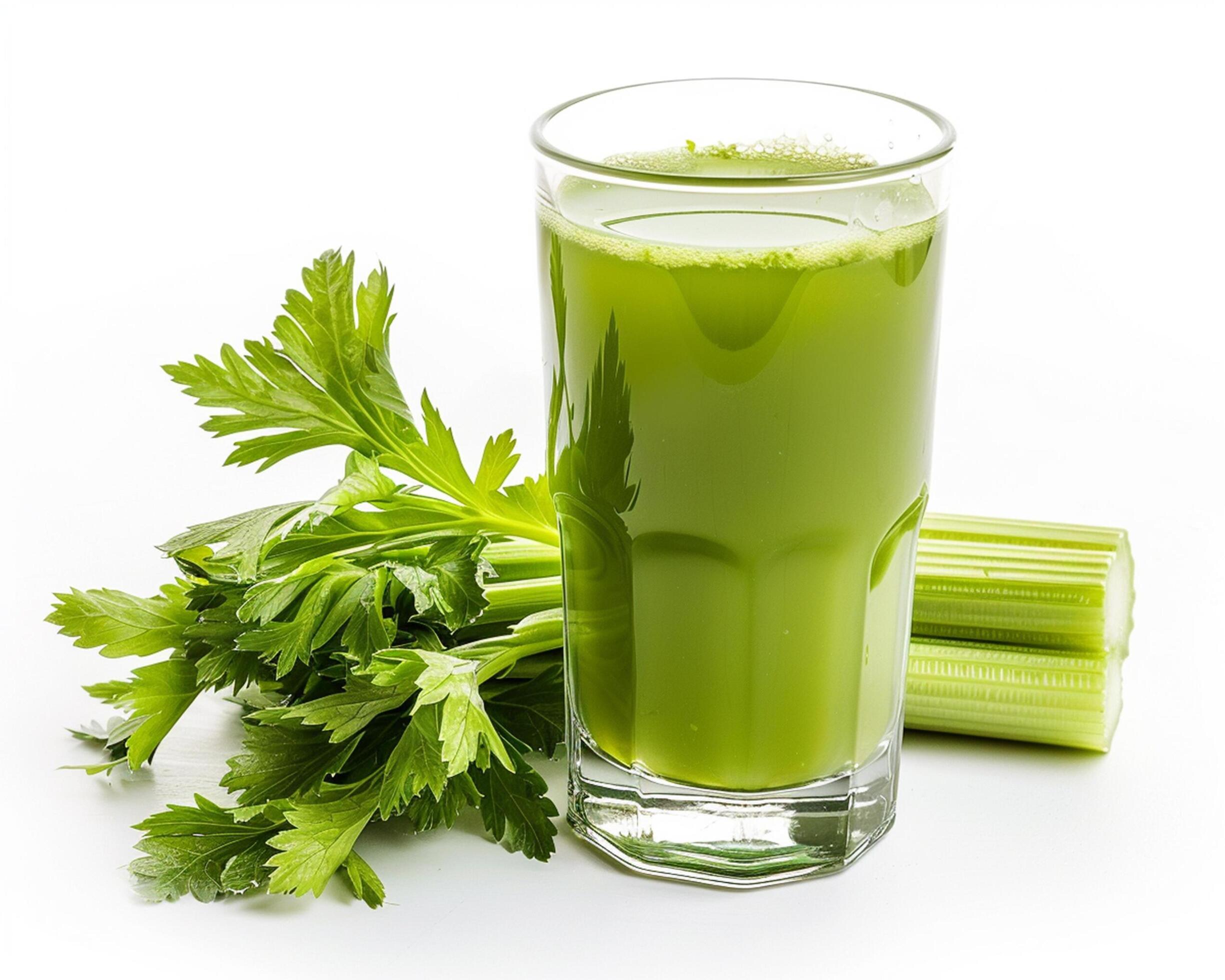 a glass of green juice with celery and celery Stock Free