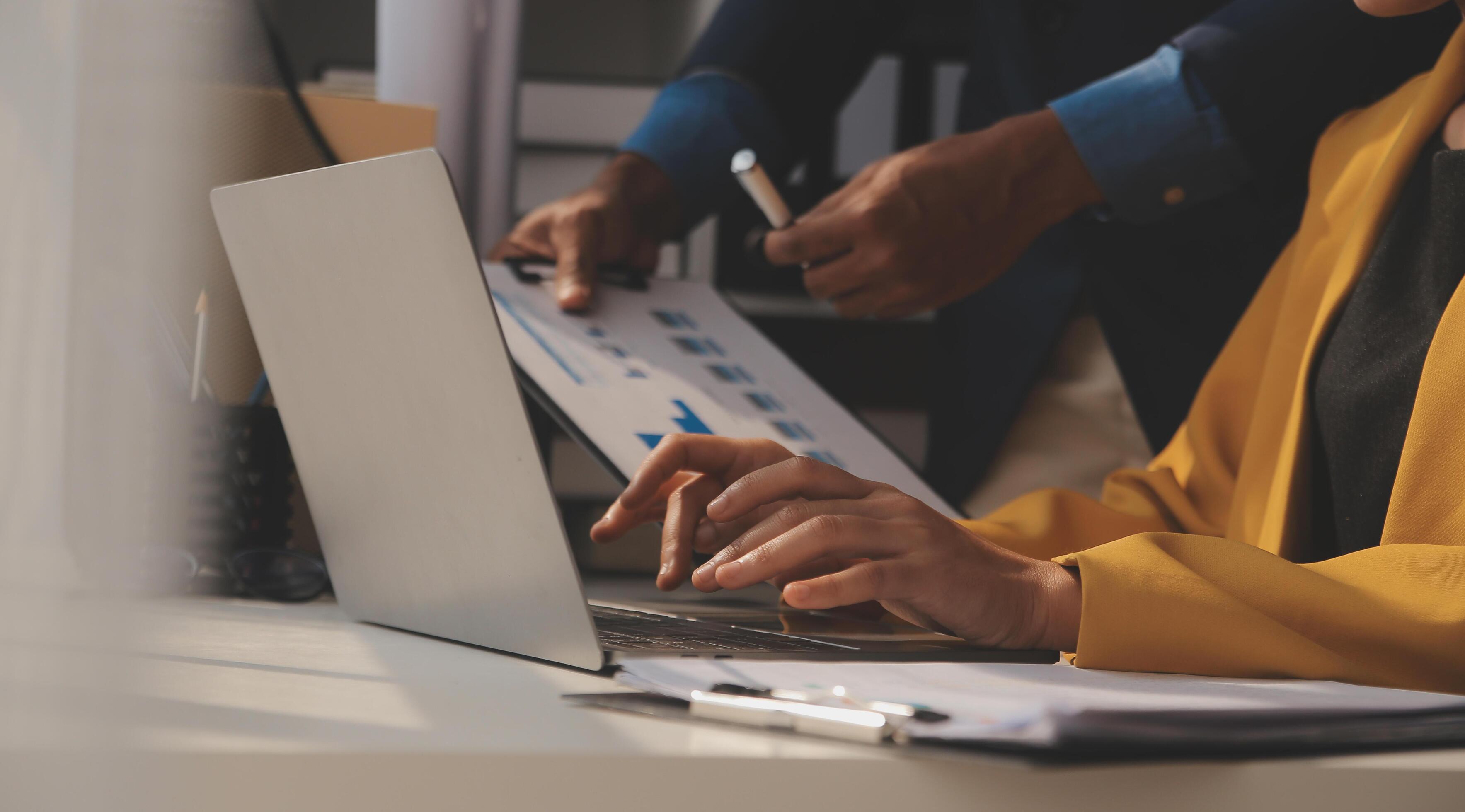 Close up of Business team analyzing income charts and graphs with modern laptop computer. Business analysis and strategy concept. Stock Free