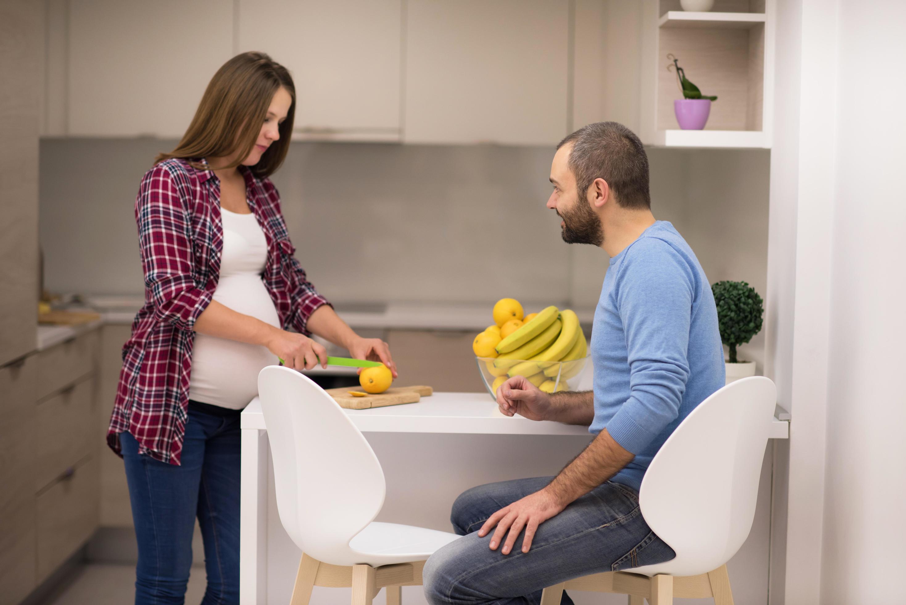 couple cooking food fruit lemon juice at kitchen Stock Free