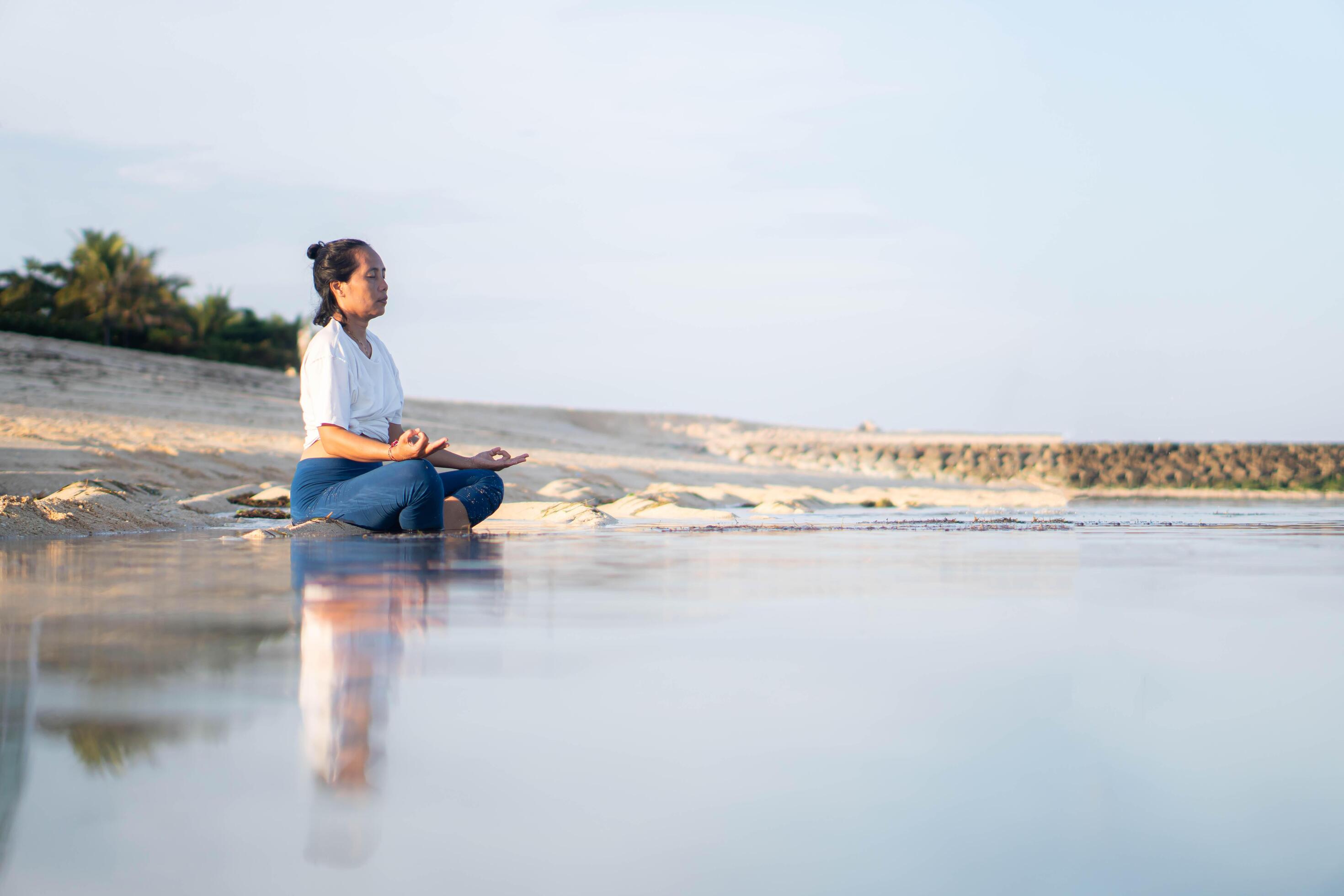 healthy woman with beautiful body doing yoga at sunrise on the beach, yoga poses Stock Free