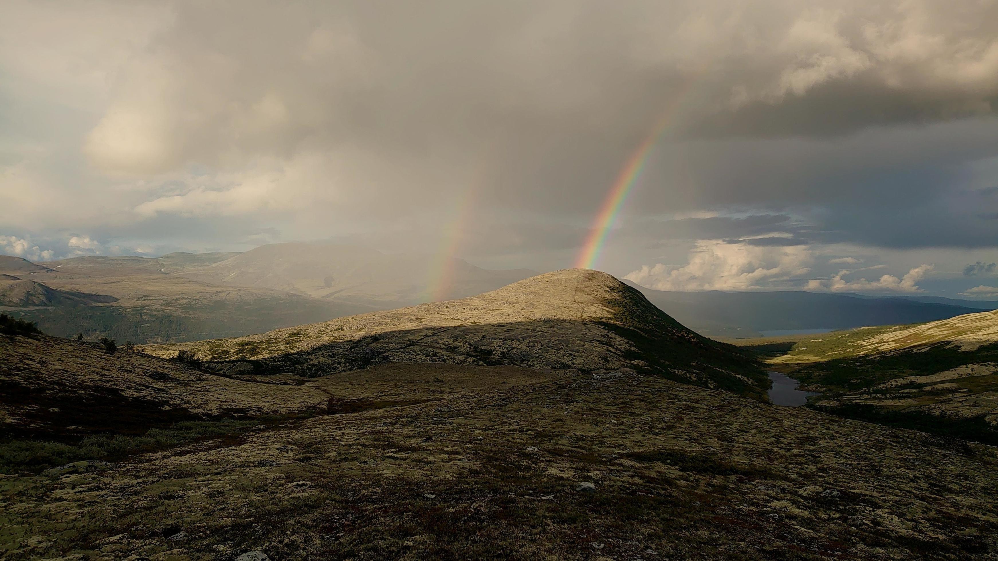 Rainbows over mountains Stock Free