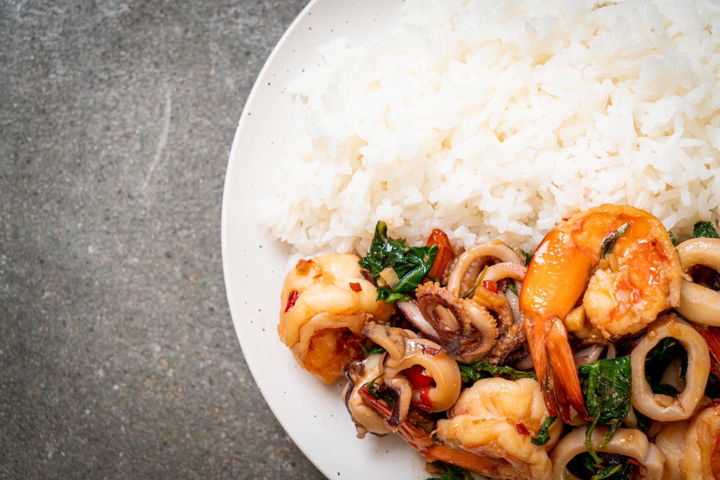 Rice and stir-fried seafood of shrimp and squid with Thai basil – Asian food style Stock Free