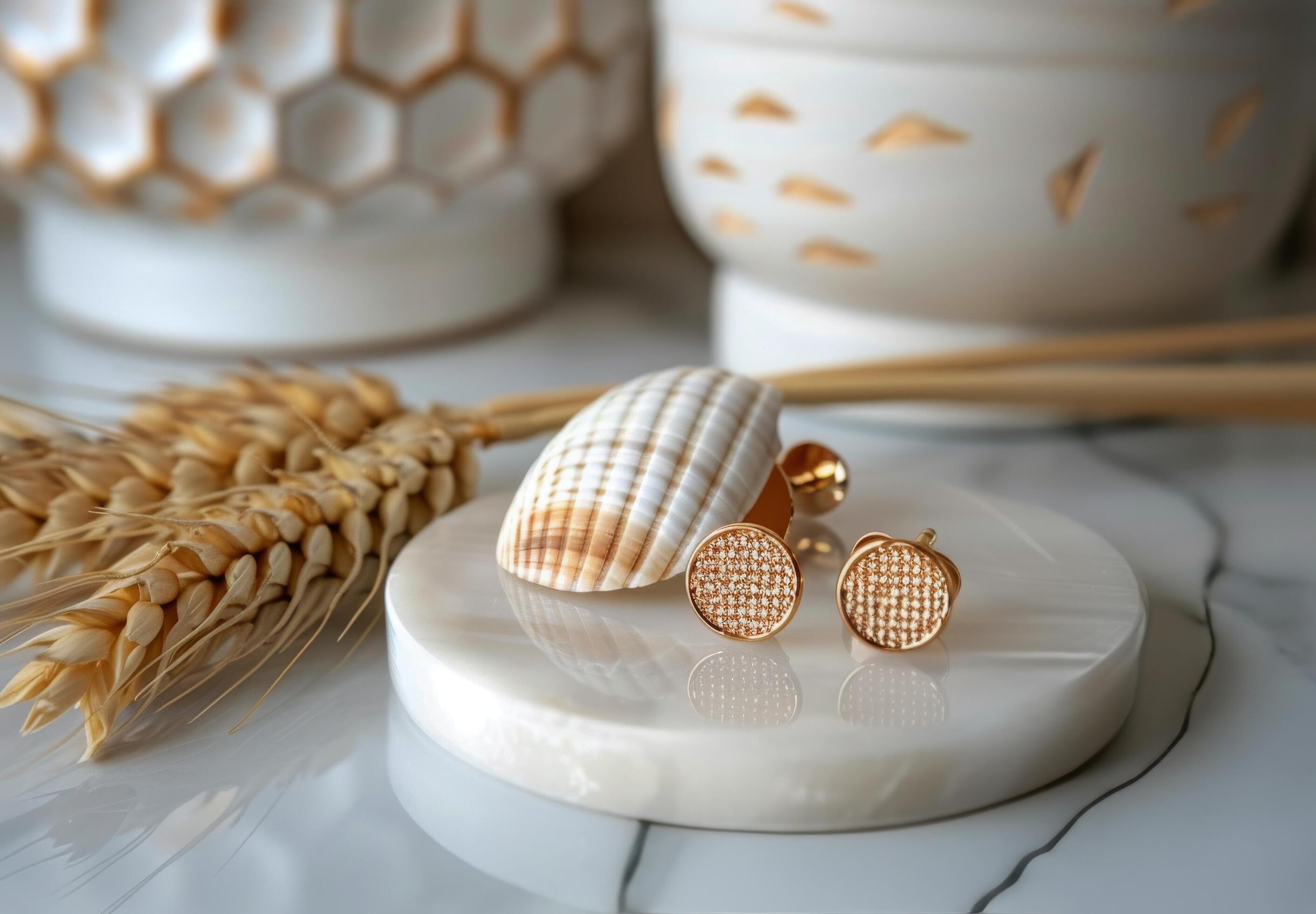 Gold Round Diamond Stud Earrings on White Marble Tray With Seashell and Wheat Stock Free