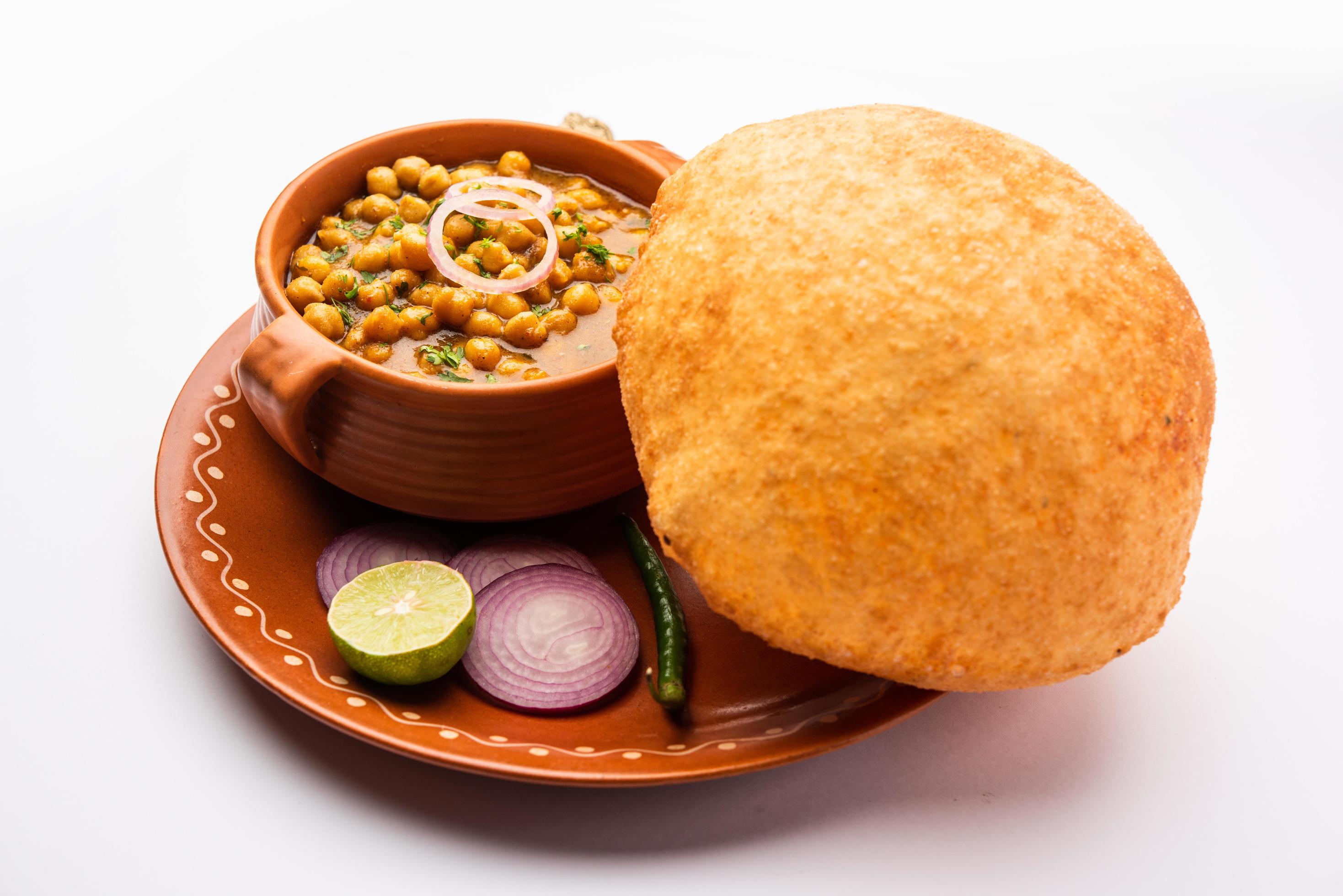 Chole bhature is a North Indian food dish. A combination of chana masala and bhatura or puri Stock Free