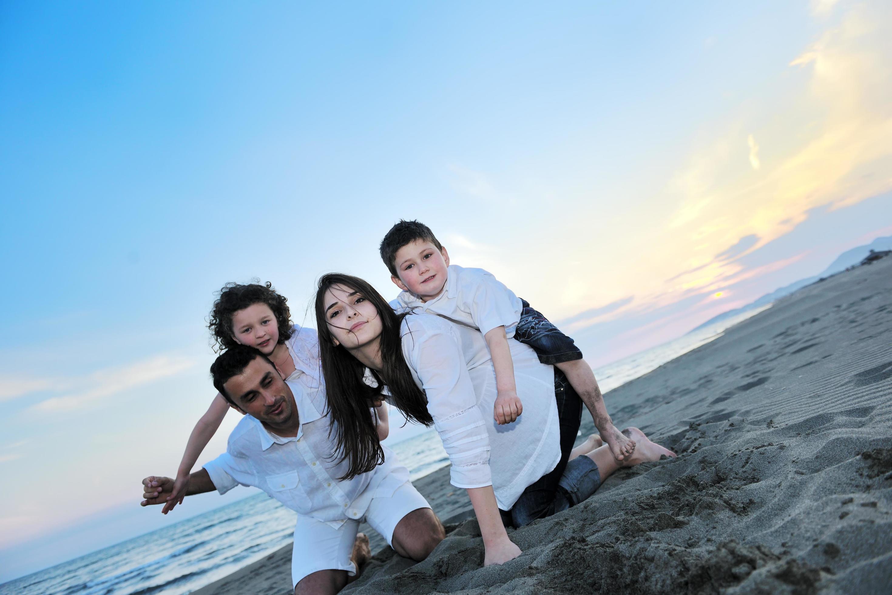 happy young family have fun on beach Stock Free