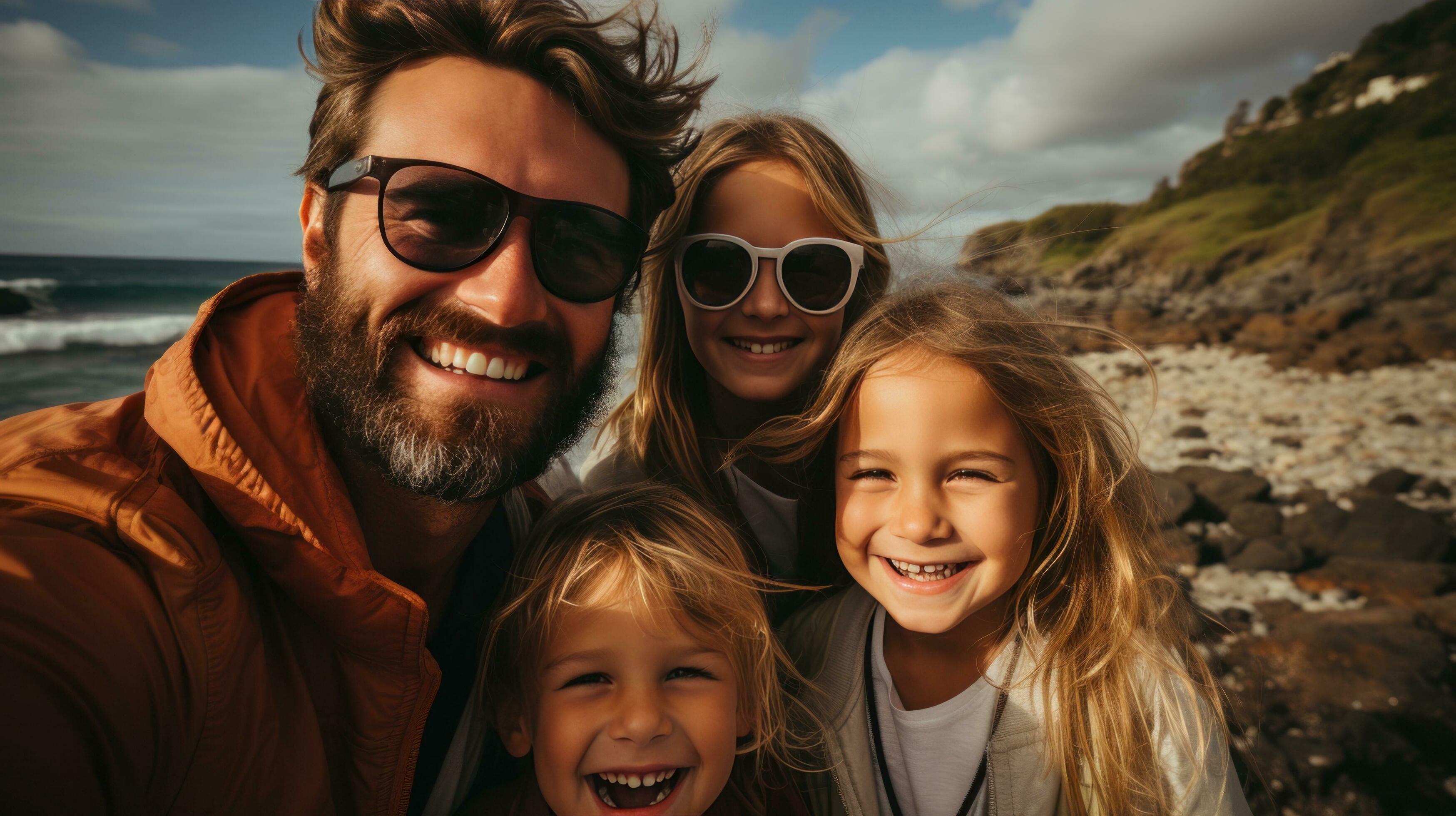 Excited family taking a group selfie on the shore Stock Free