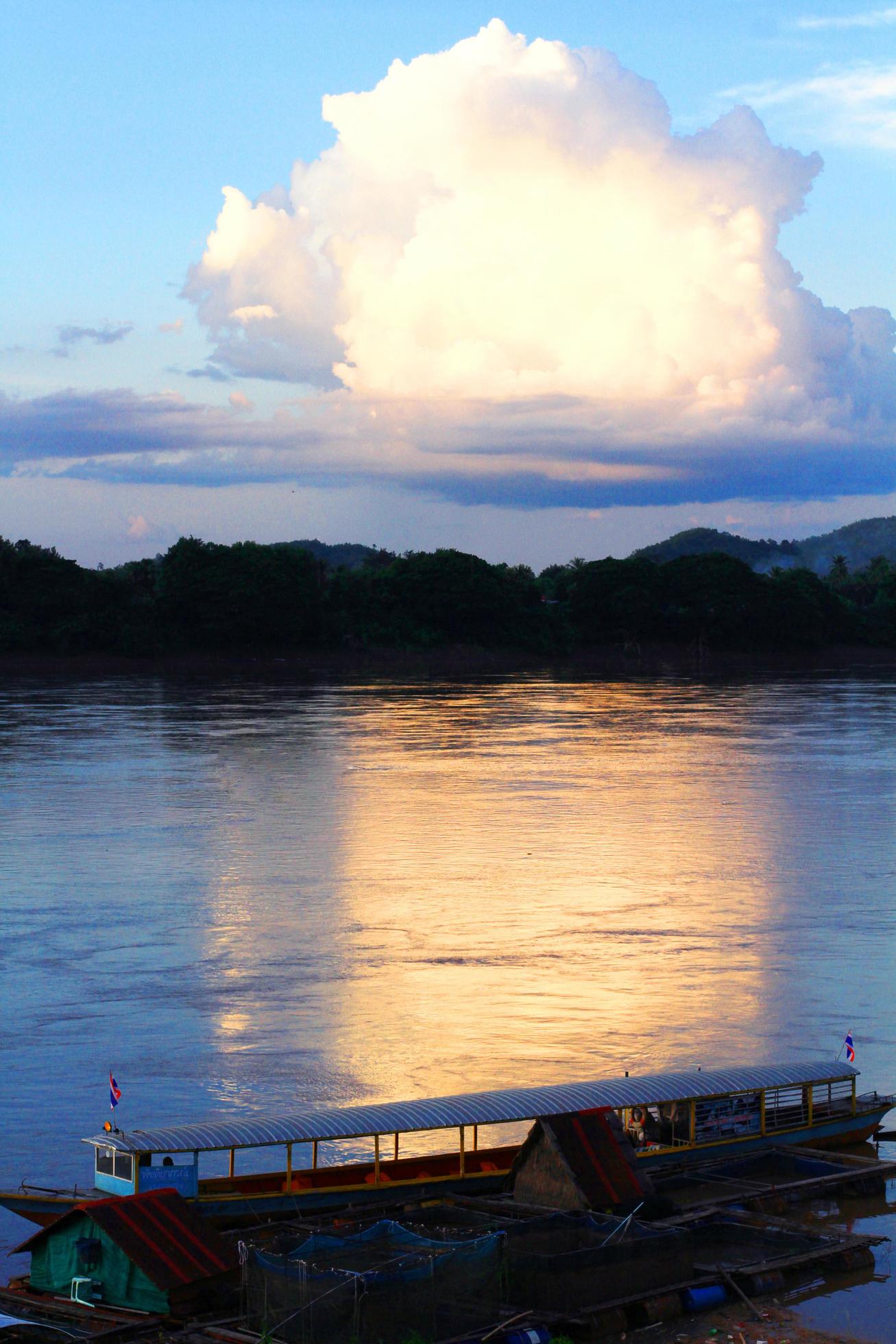 Tradition of Long tail boat and fisherman in beautiful sunset twilight at Khong river the Thai-Laos border Chaingkhan distric Thailand Stock Free