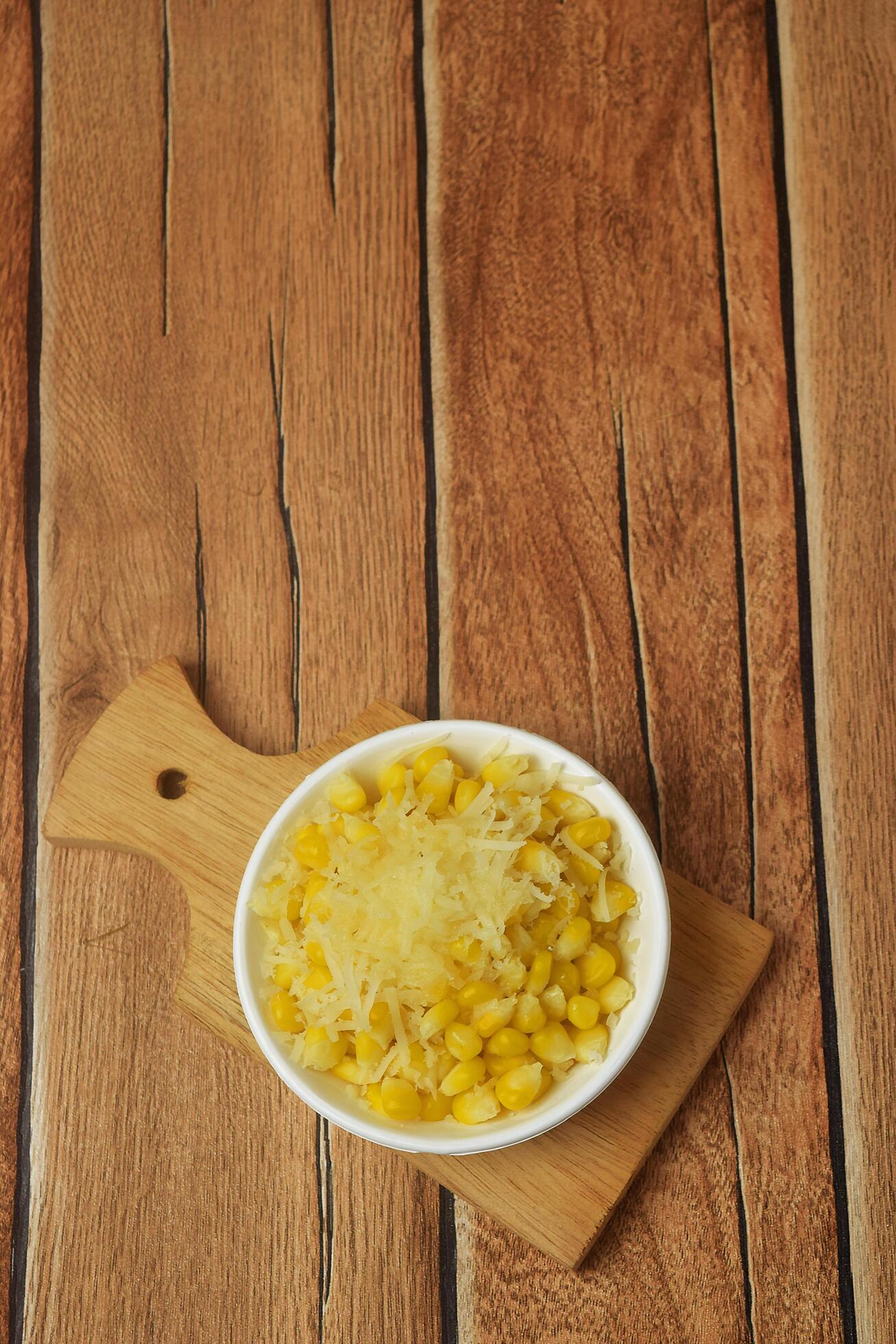 Shaved corn sprinkled with cheese and sweet milk Stock Free