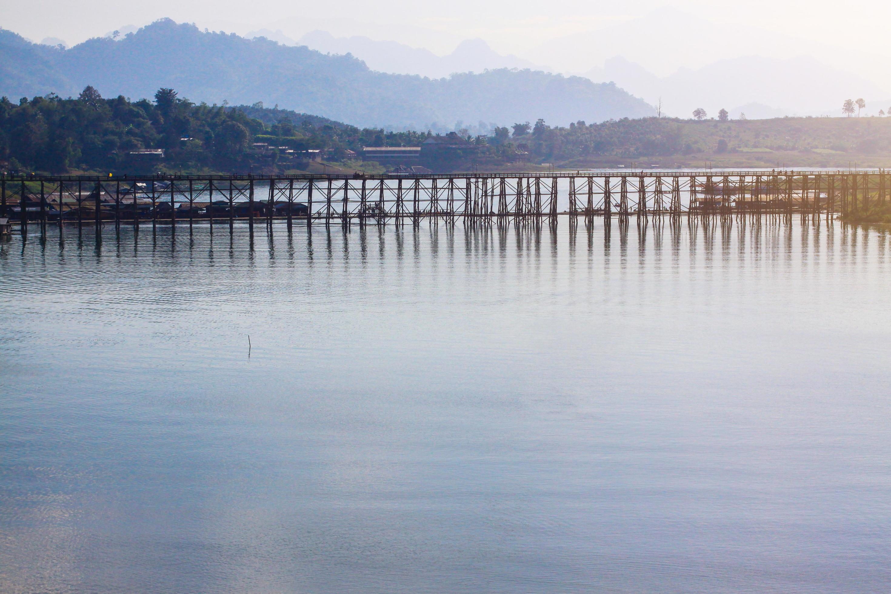 Beautiful sunrise on the Mon wooden Bridge with blue sky in sangkhlaburi, Thailand Stock Free