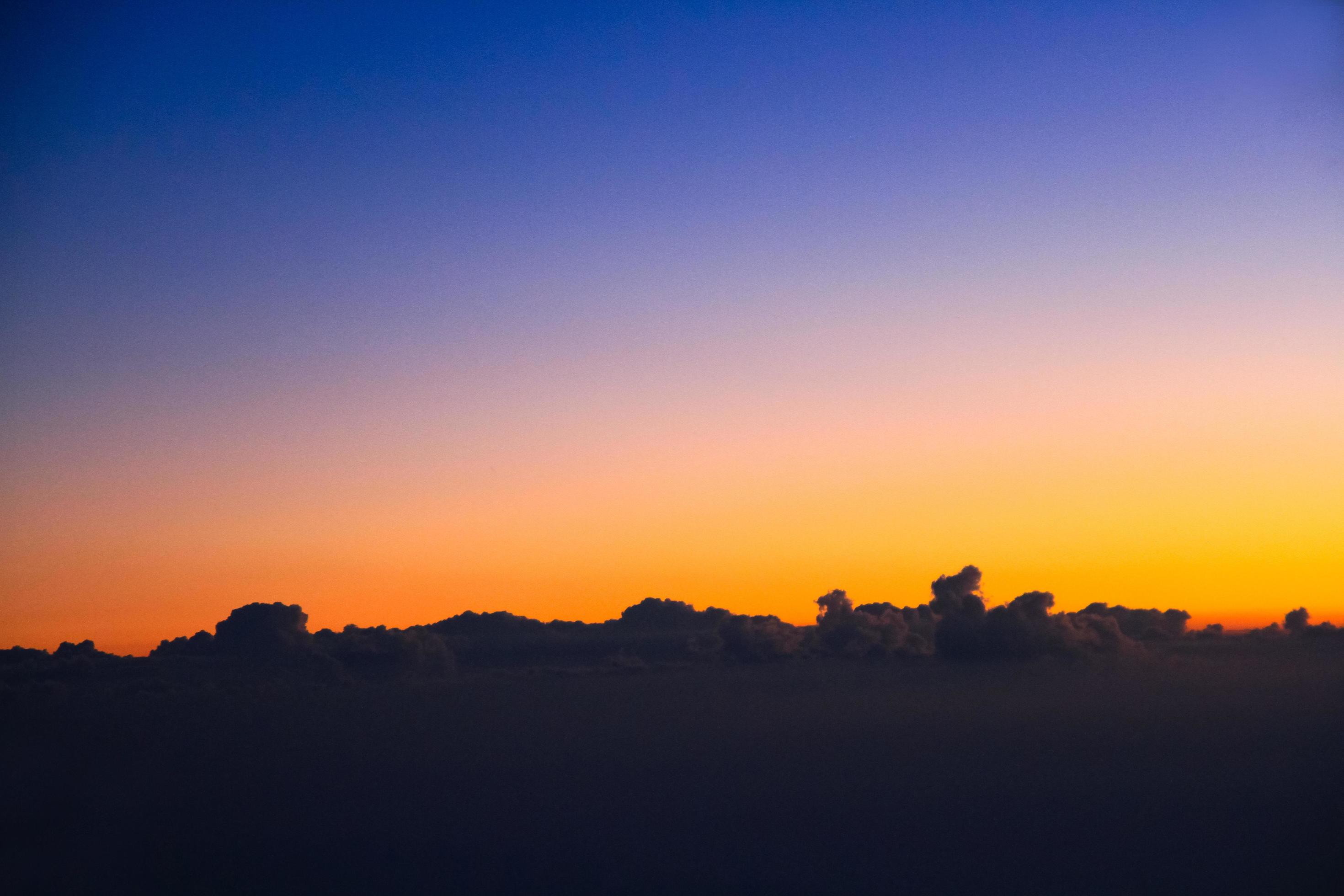 Sunset in sky and cloud, beautiful colorful twilight time with silhouette of mountain. Stock Free