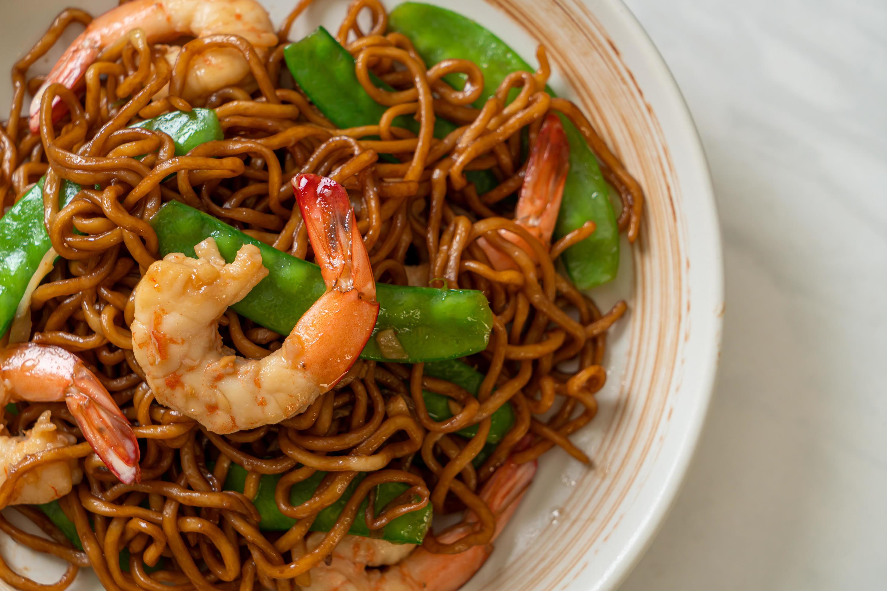 Stir-fried yakisoba noodles with green peas and shrimps – Asian food style Stock Free