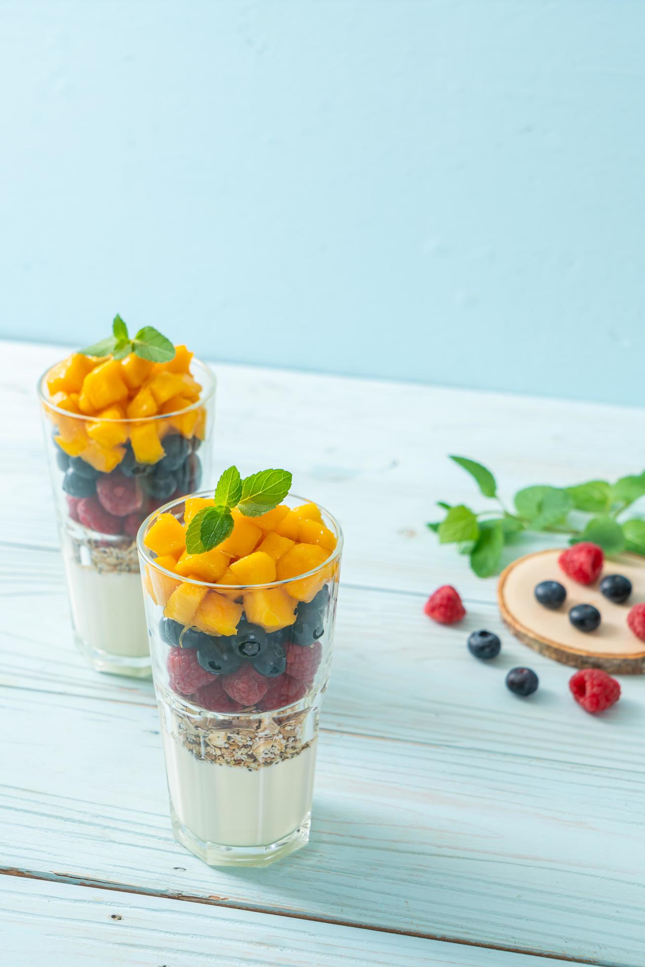 Homemade mango, raspberry, and blueberry with yogurt and granola – healthy food style Stock Free