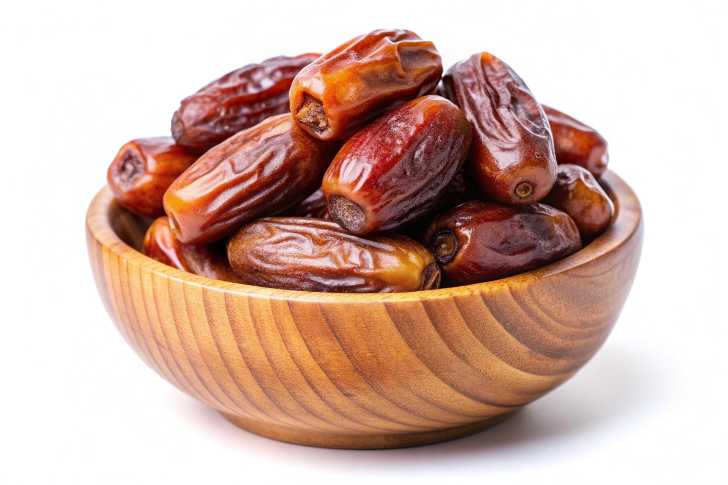 Dates in wood bowl isolated on white background Stock Free