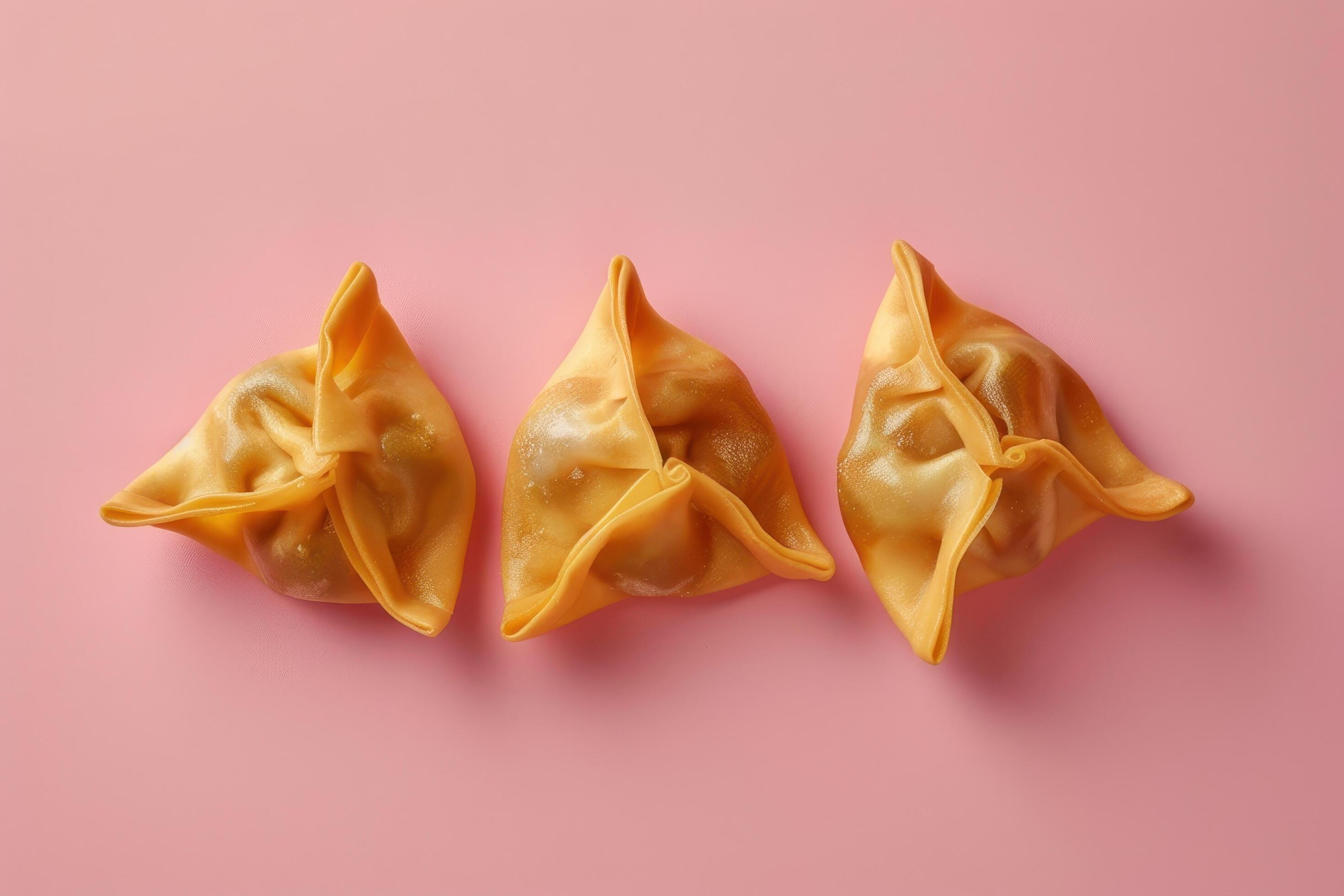 Three Golden Dumplings on Pink Background Stock Free