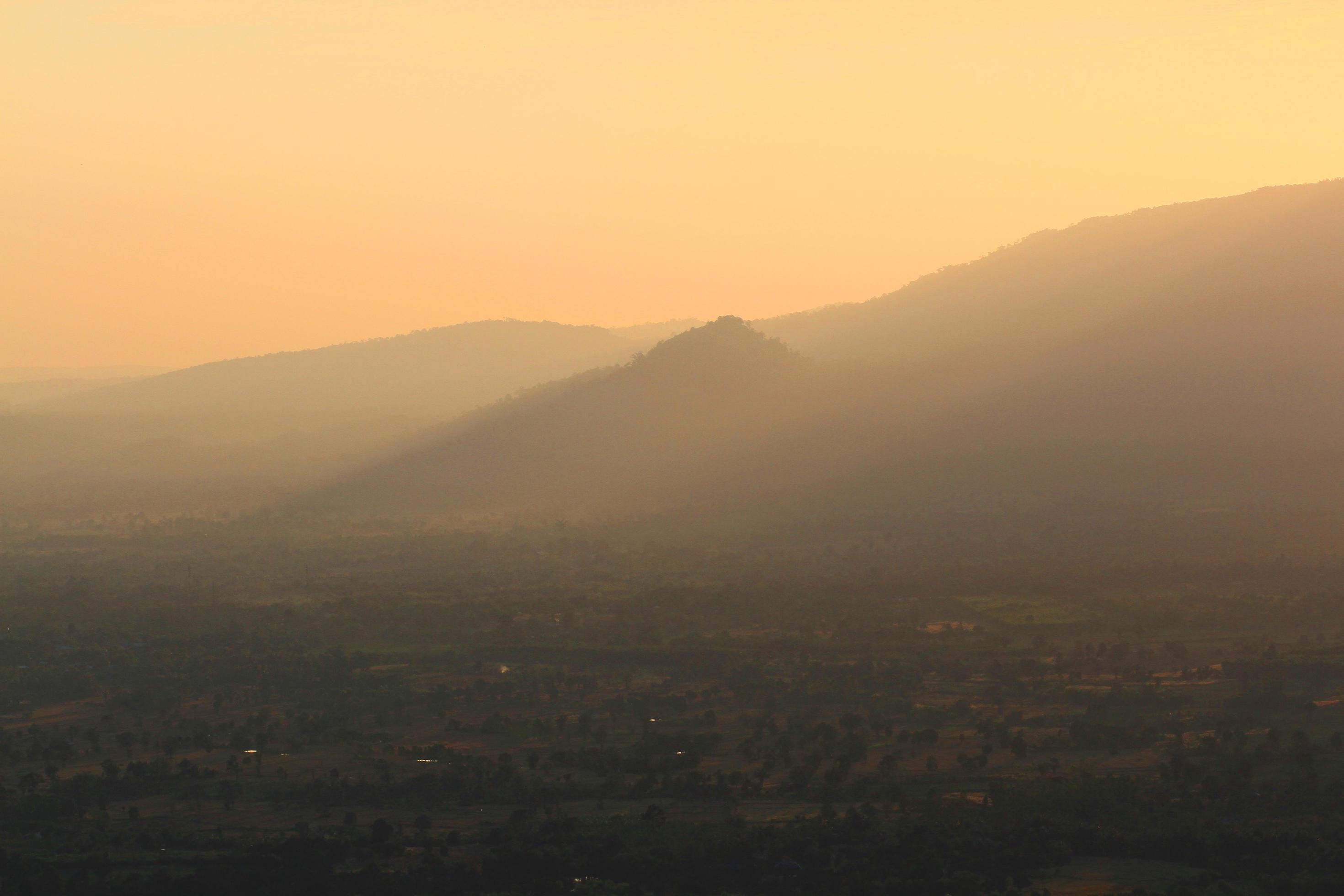 Beautiful landscape layers of mountain and Misty on hill valley in golden twilight of sunset at Thailand Stock Free