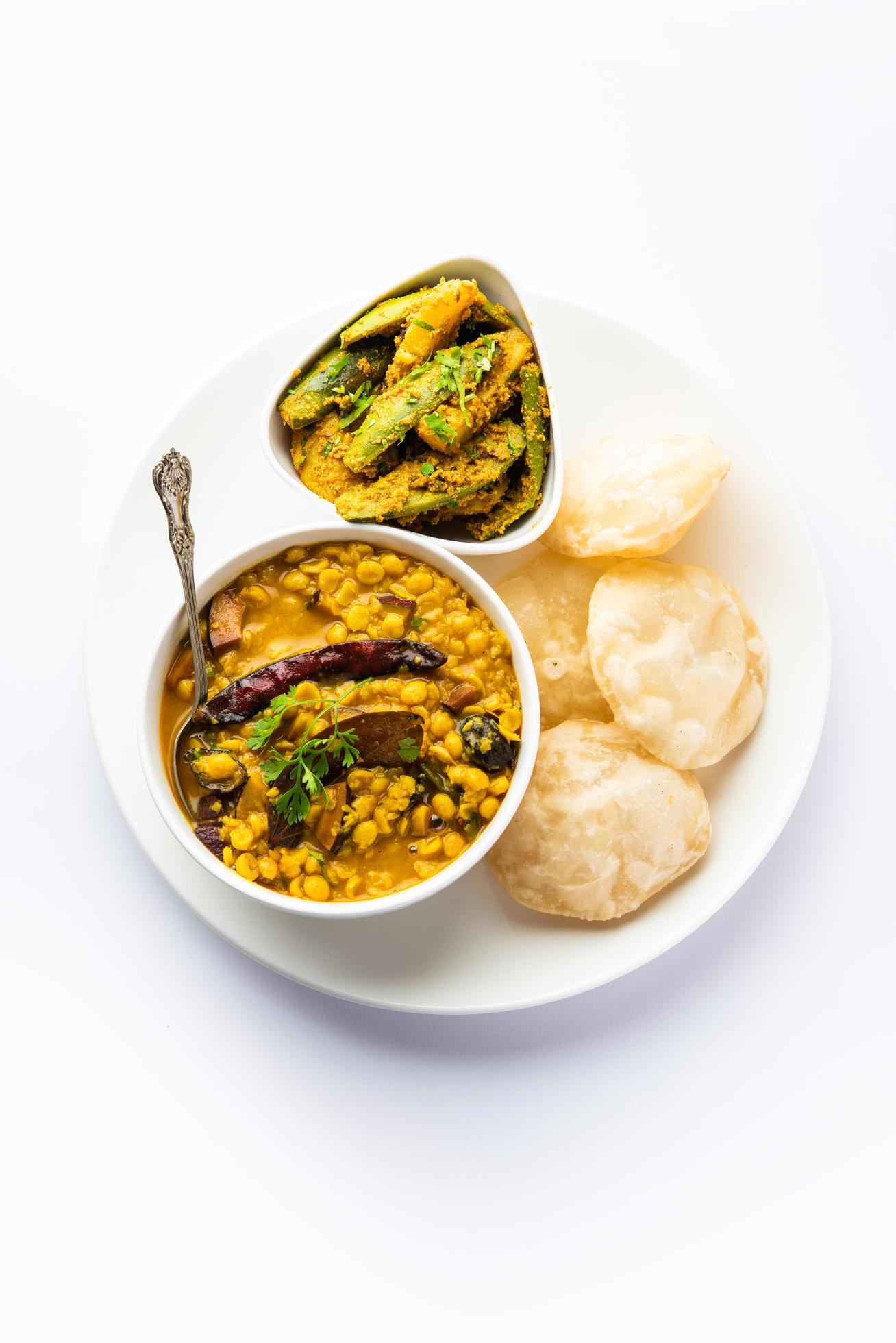 Cholar dal and patol aloo sabzi served with fried Luchi or poori, bengali food Stock Free