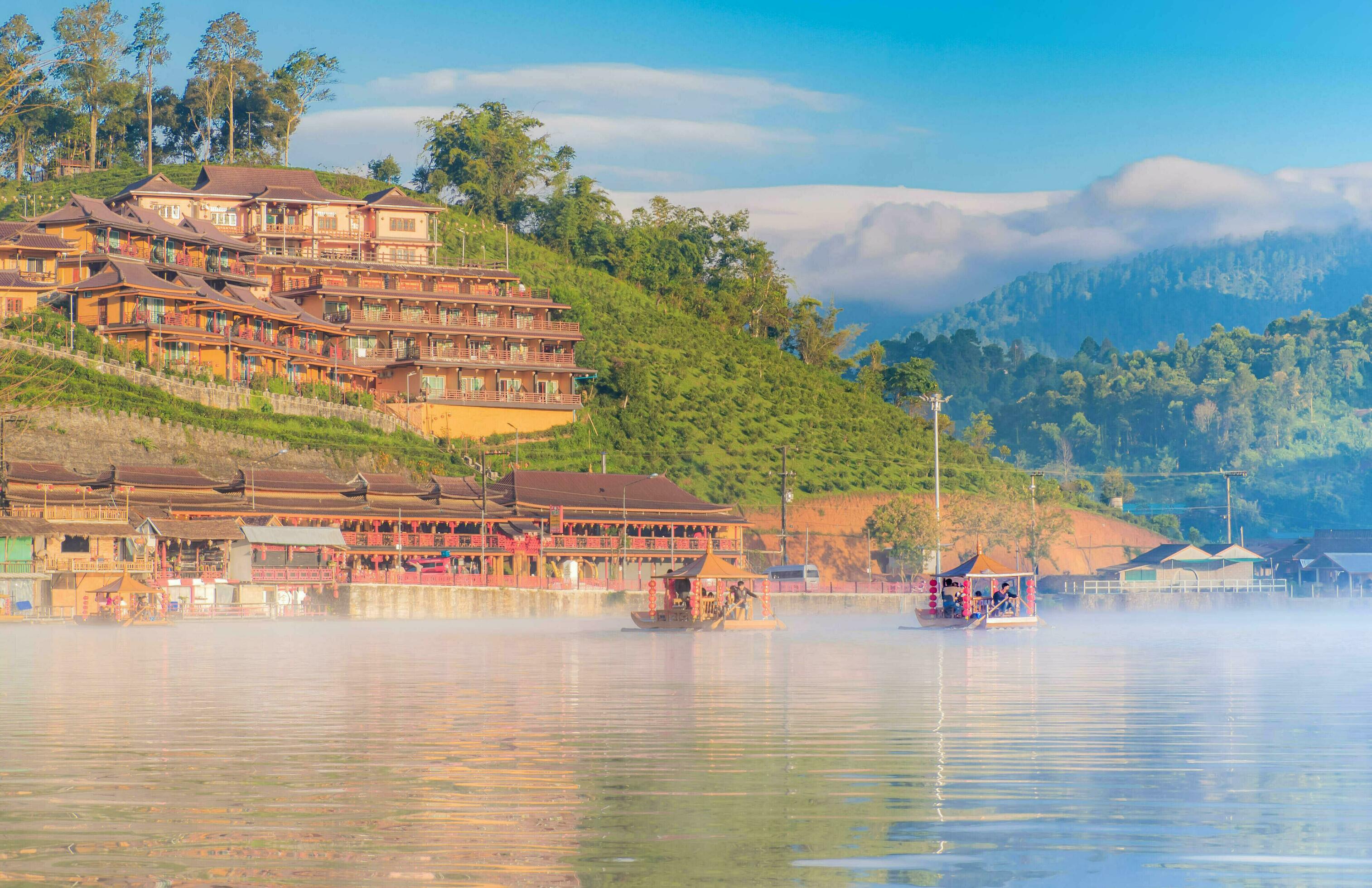 Chinese boat launched early in the morning at Rak Thai hamlet in Maehongson, Thailand, on the lake with water vapor, Banrakthai, Ban rak thai. Stock Free