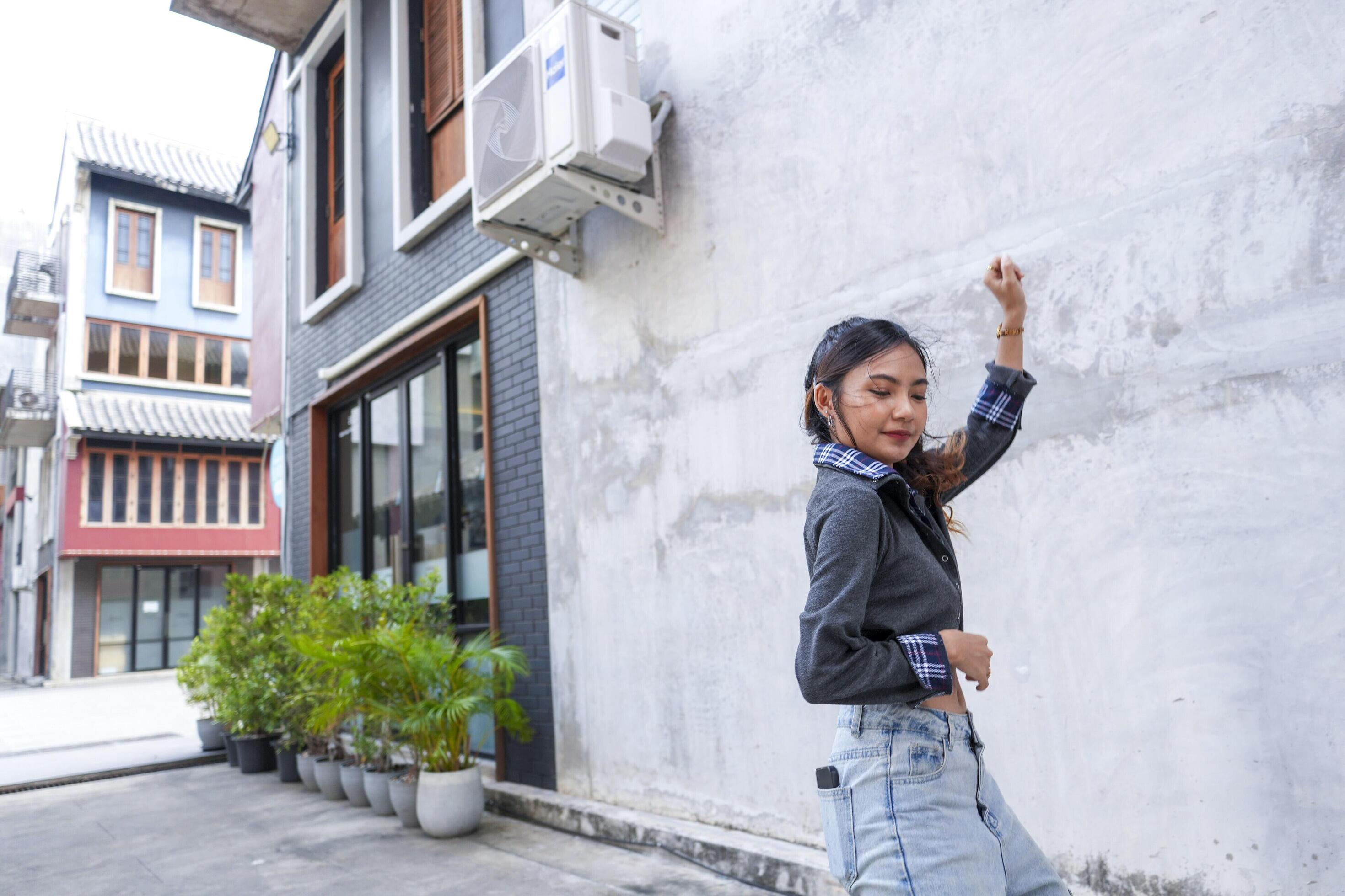 Asian women do freestyle hip hop and breakdancing in a public space in the middle of the city. With a cheerful and happy attitude Stock Free