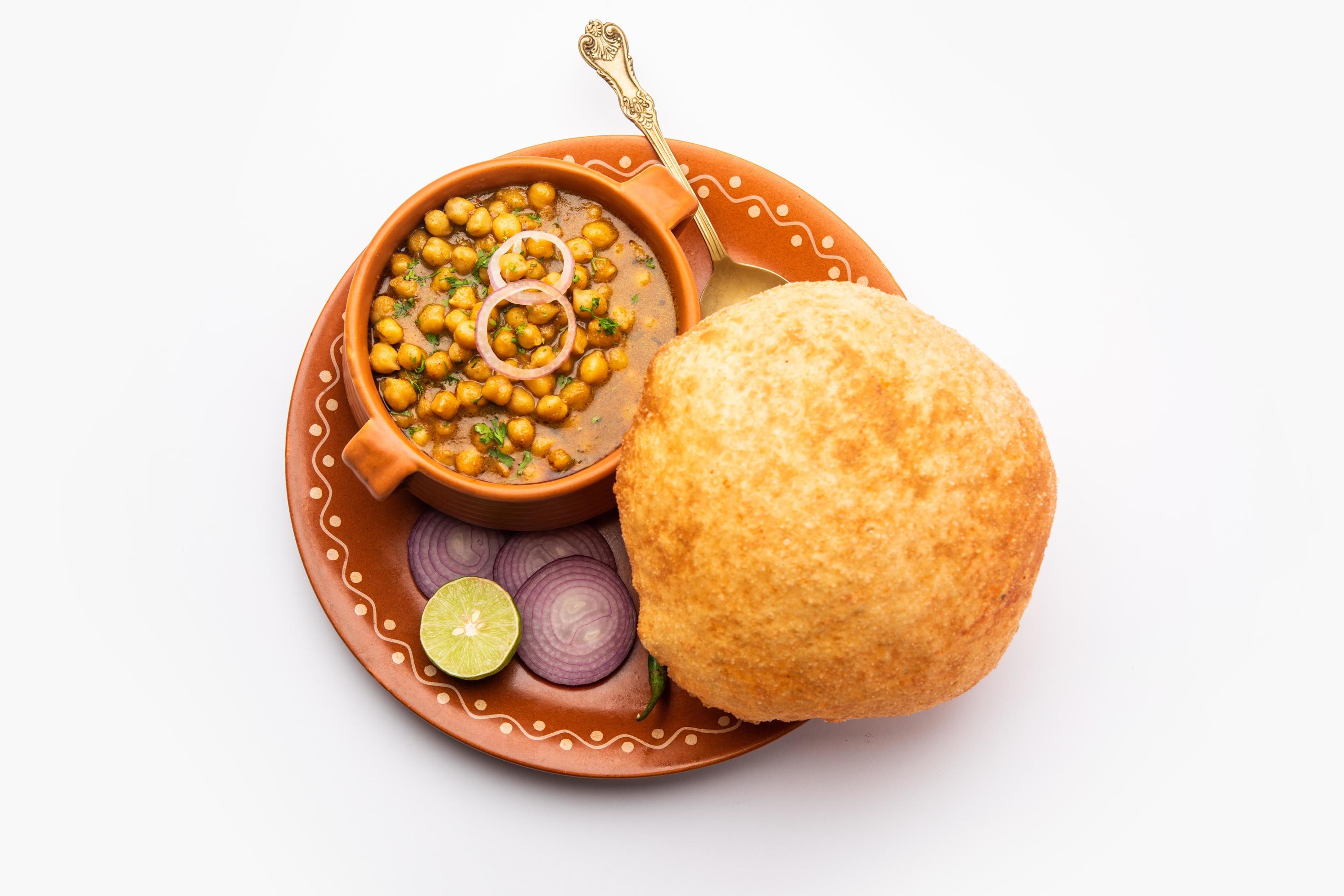 Chole bhature is a North Indian food dish. A combination of chana masala and bhatura or puri Stock Free