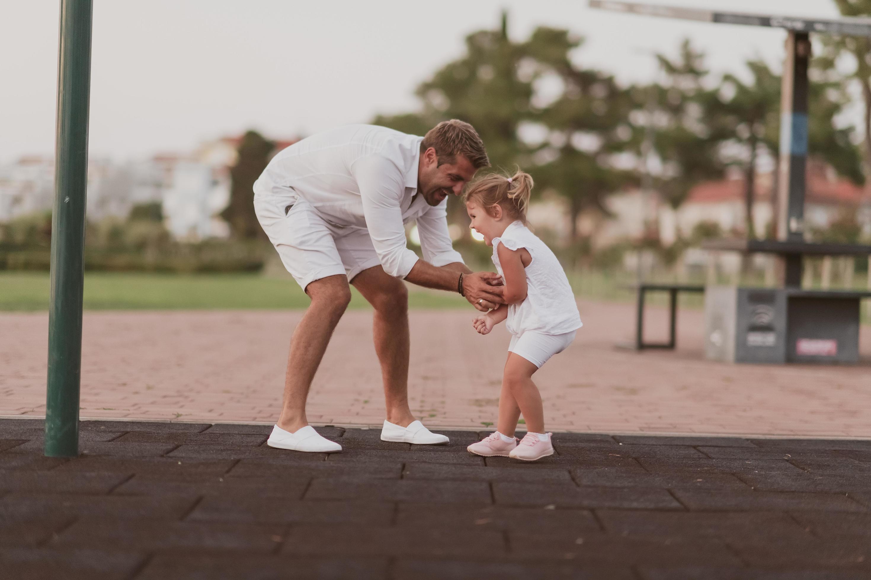 An elderly man in casual clothes with his daughter spends time together in the park on vacation. Family time. Selective focus Stock Free