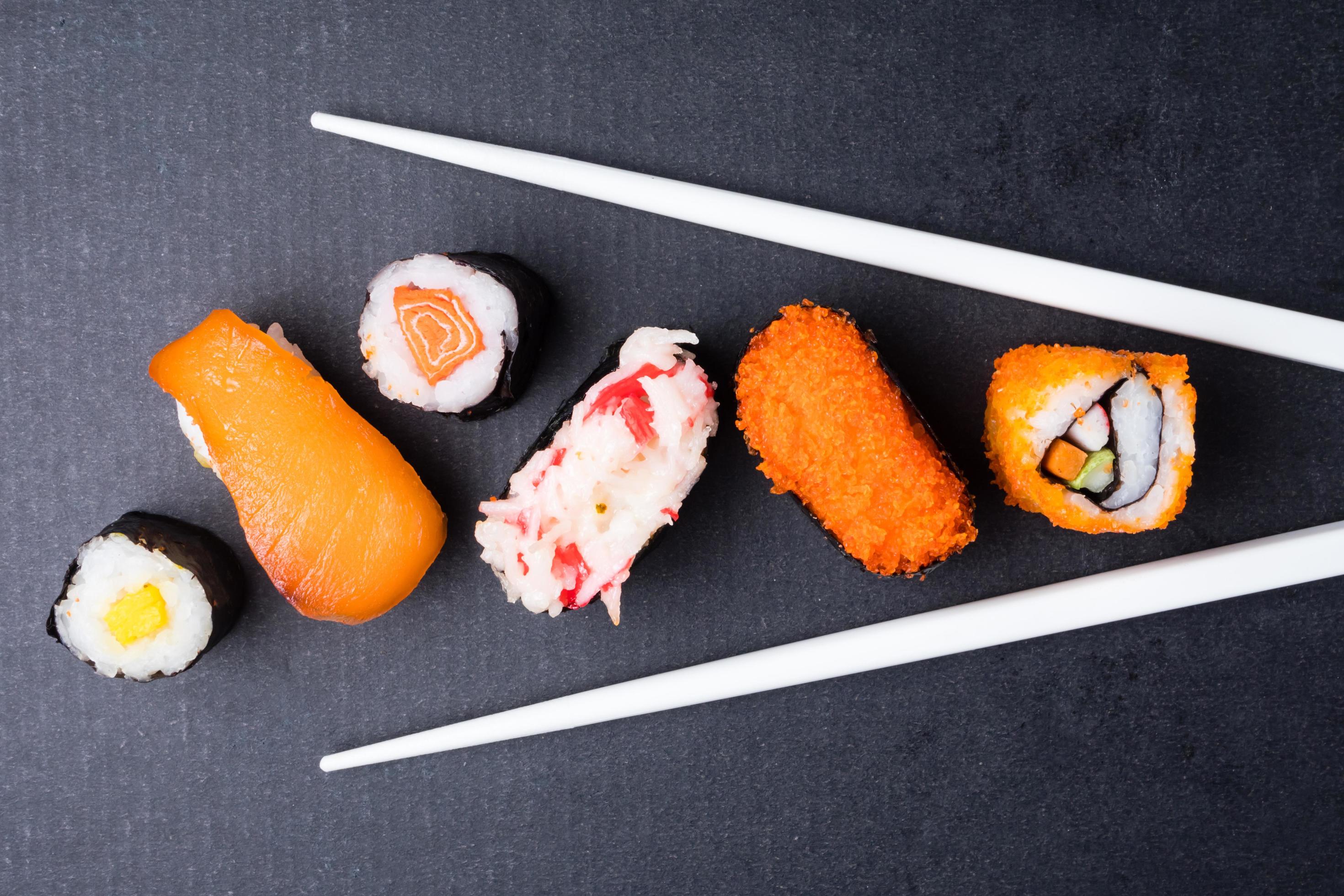 Top view of Sushi set and chopsticks on black background, Japanese food. Stock Free