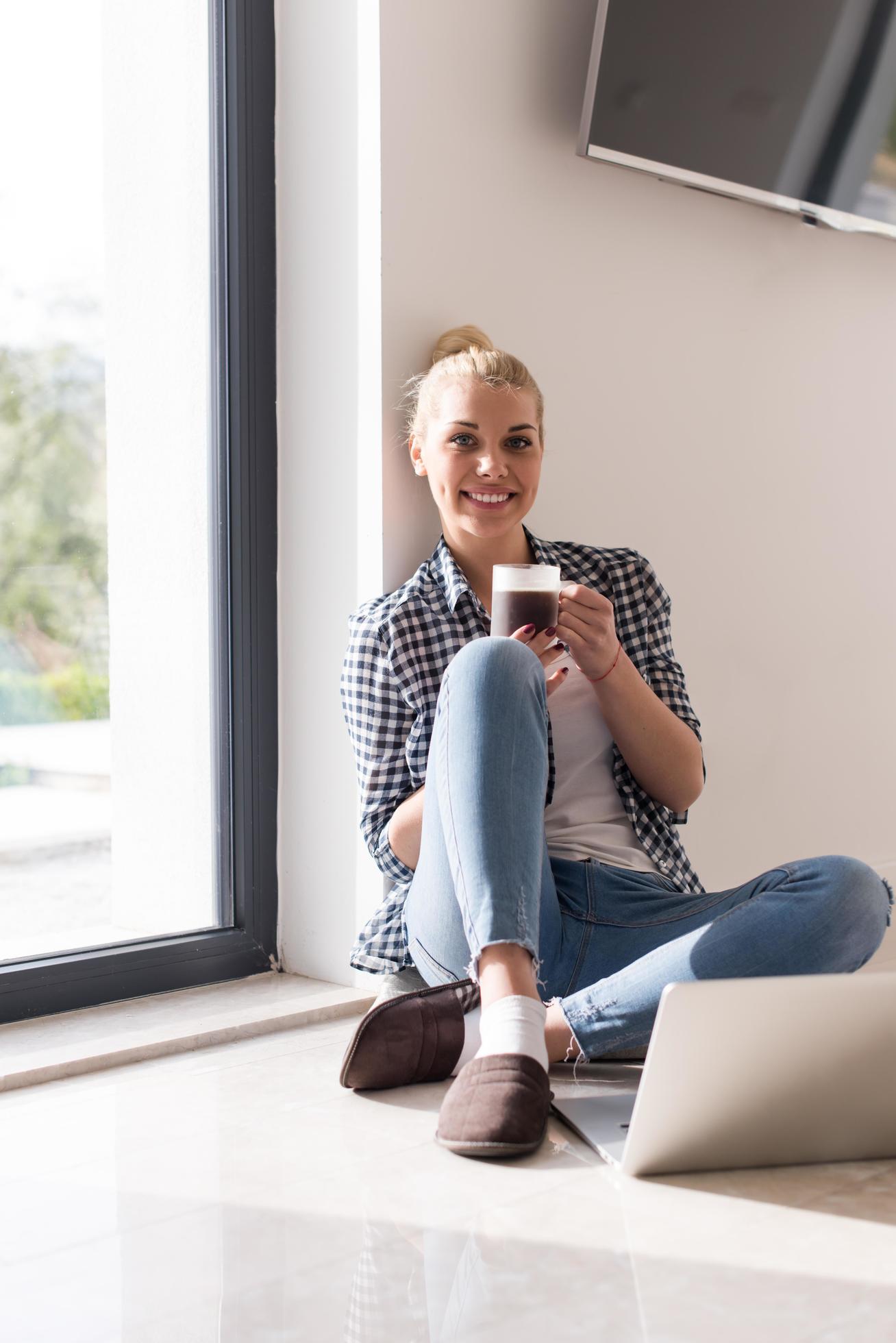 young woman drinking coffee enjoying relaxing lifestyle Stock Free