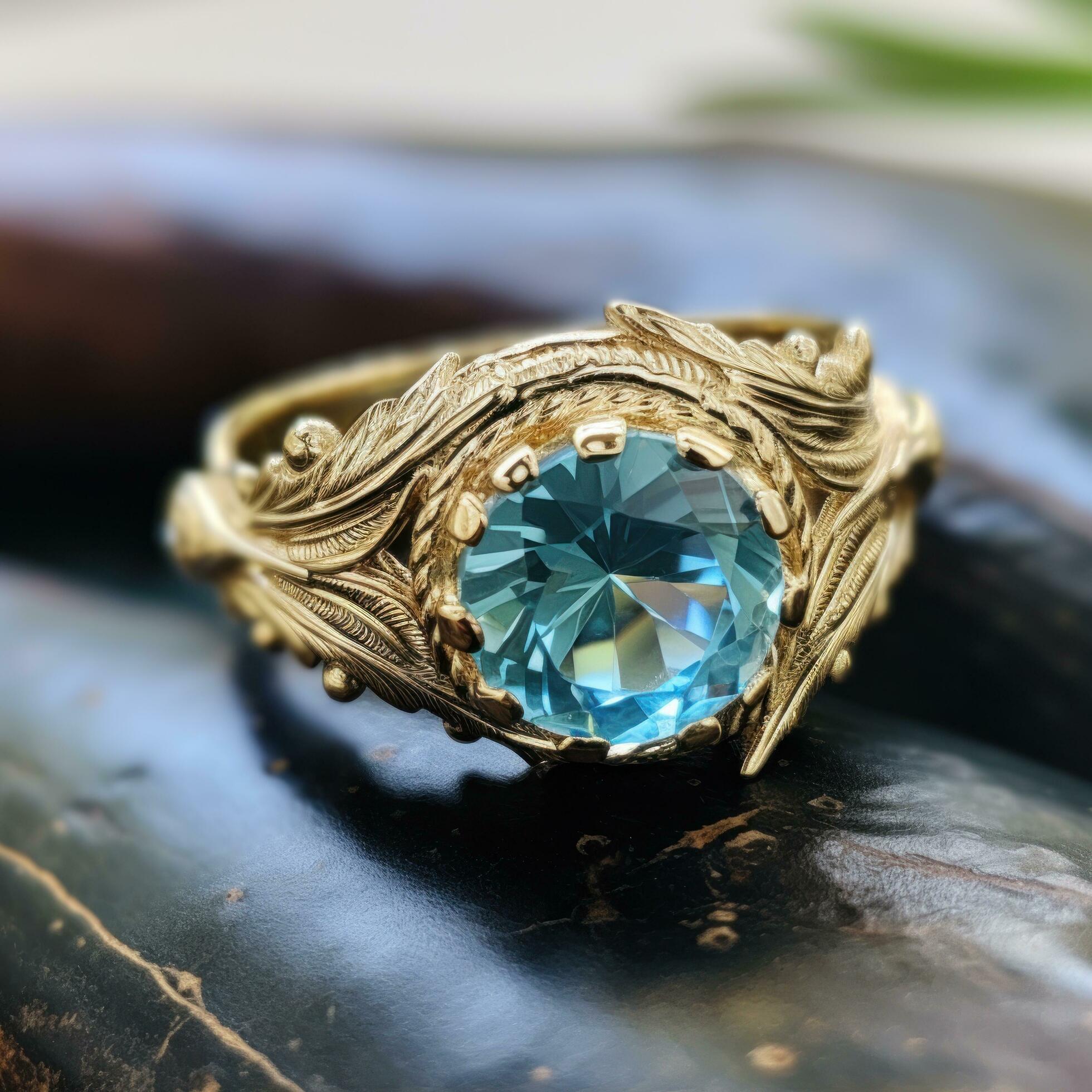 a round blue topaz ring with feathers Free Photo