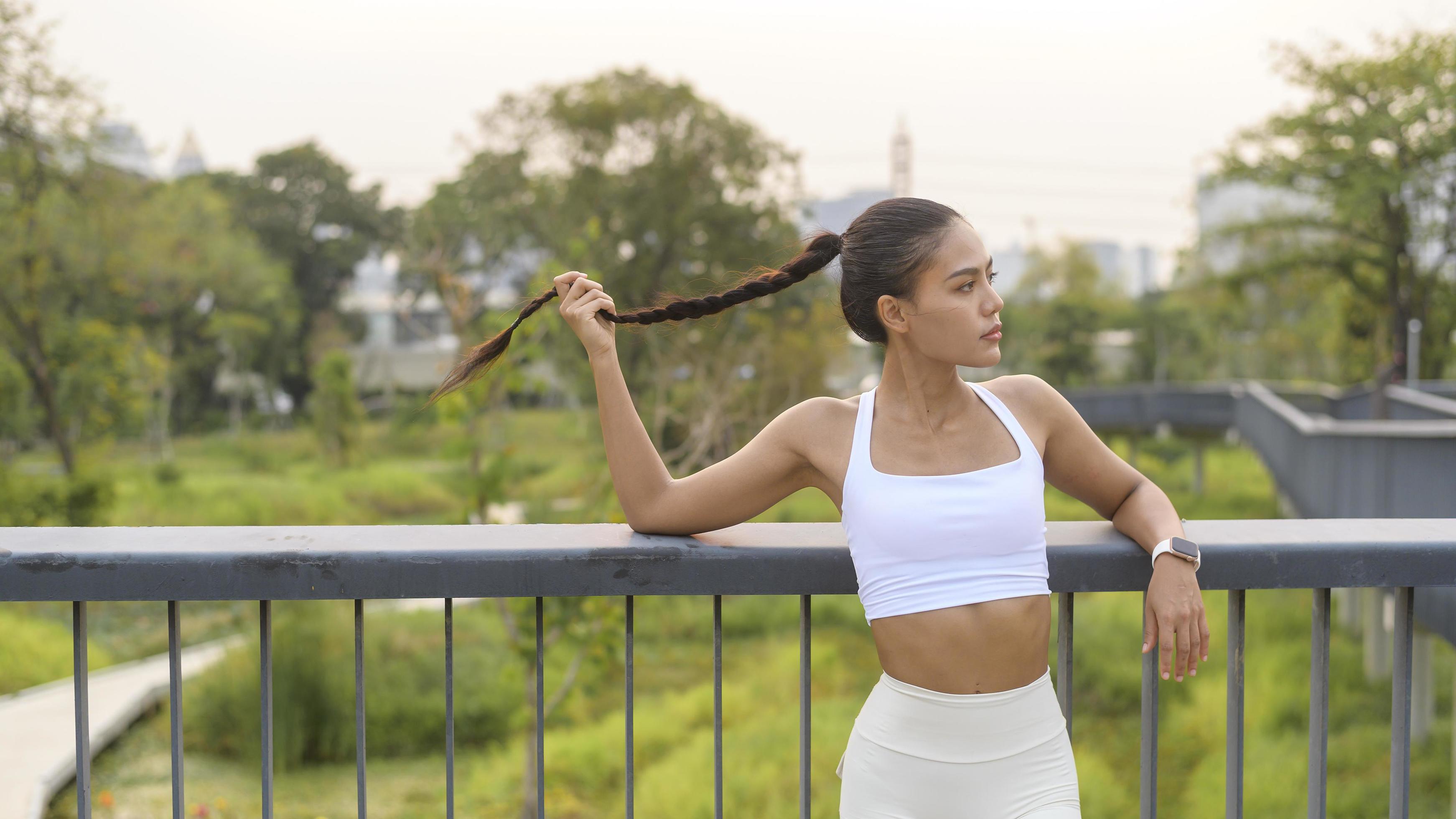 Portrait of young fitness woman in sportswear in city park, Healthy and Lifestyles. Stock Free