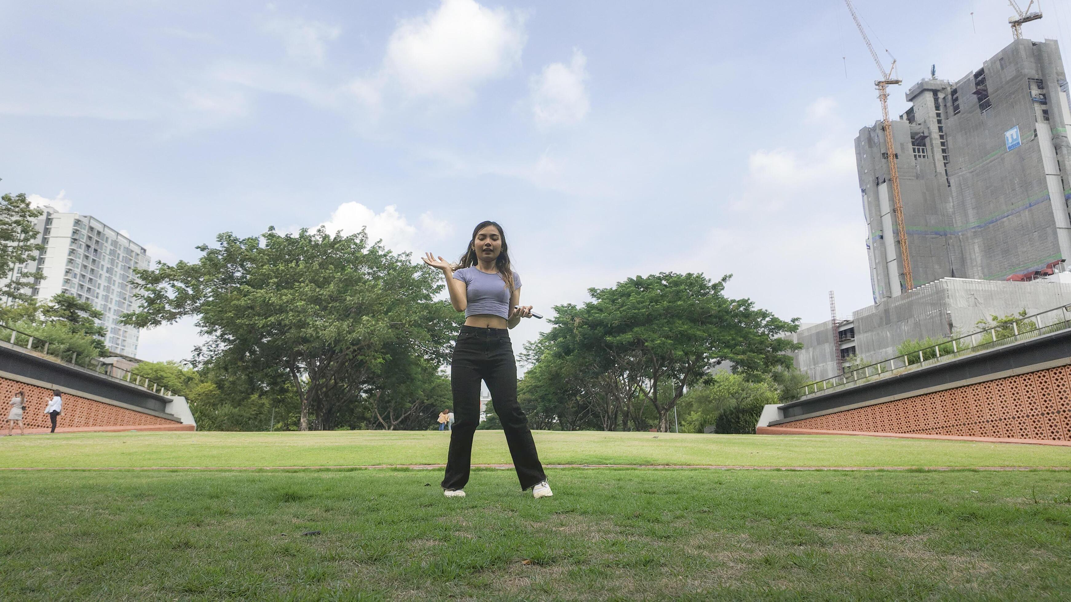 Asian women do freestyle hip hop and breakdancing in a public space in the middle of the city. With a cheerful and happy attitude Stock Free