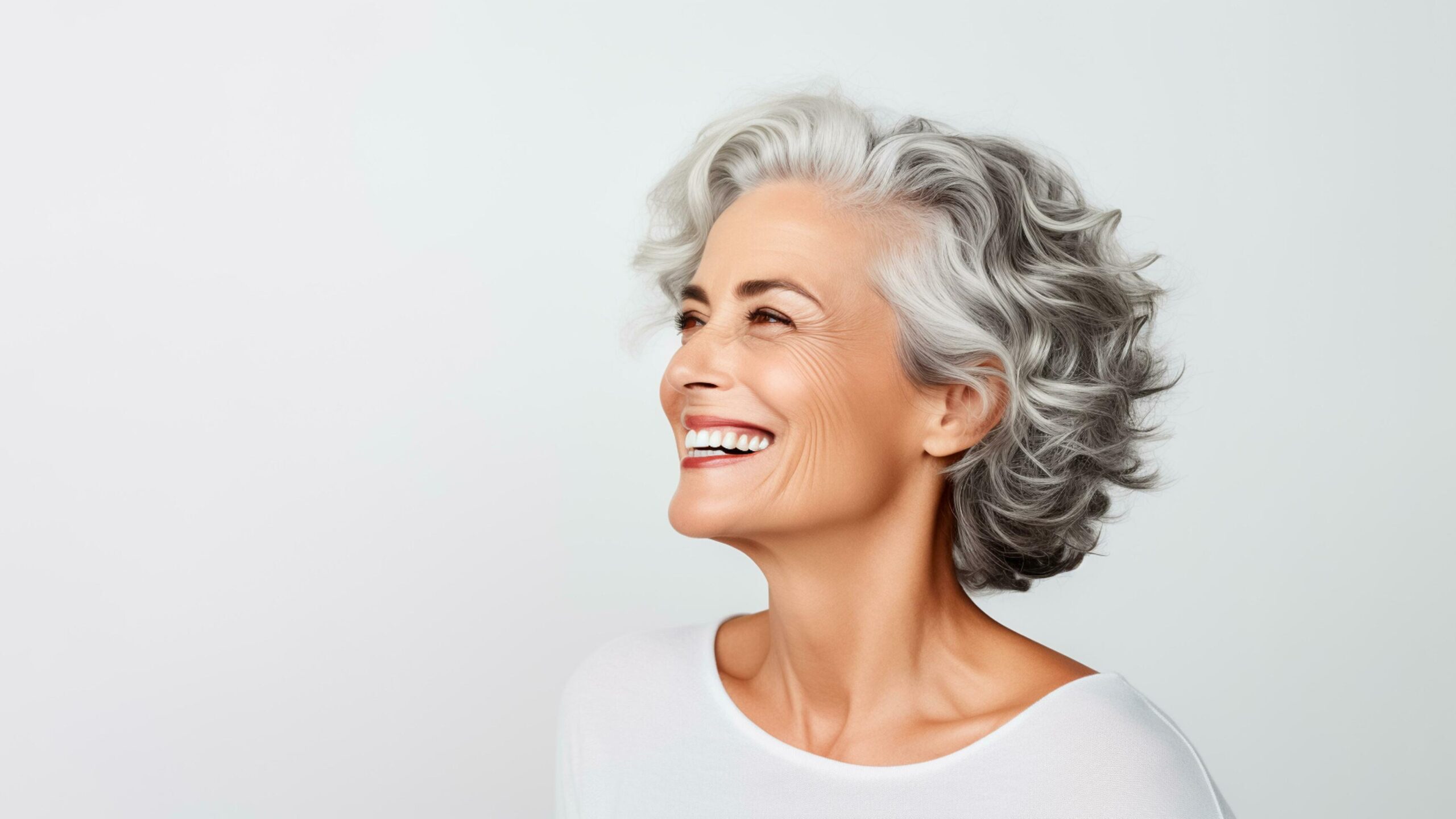 50s middle aged elderly senior model woman with grey hair smiling white background. AI Generated Free Photo