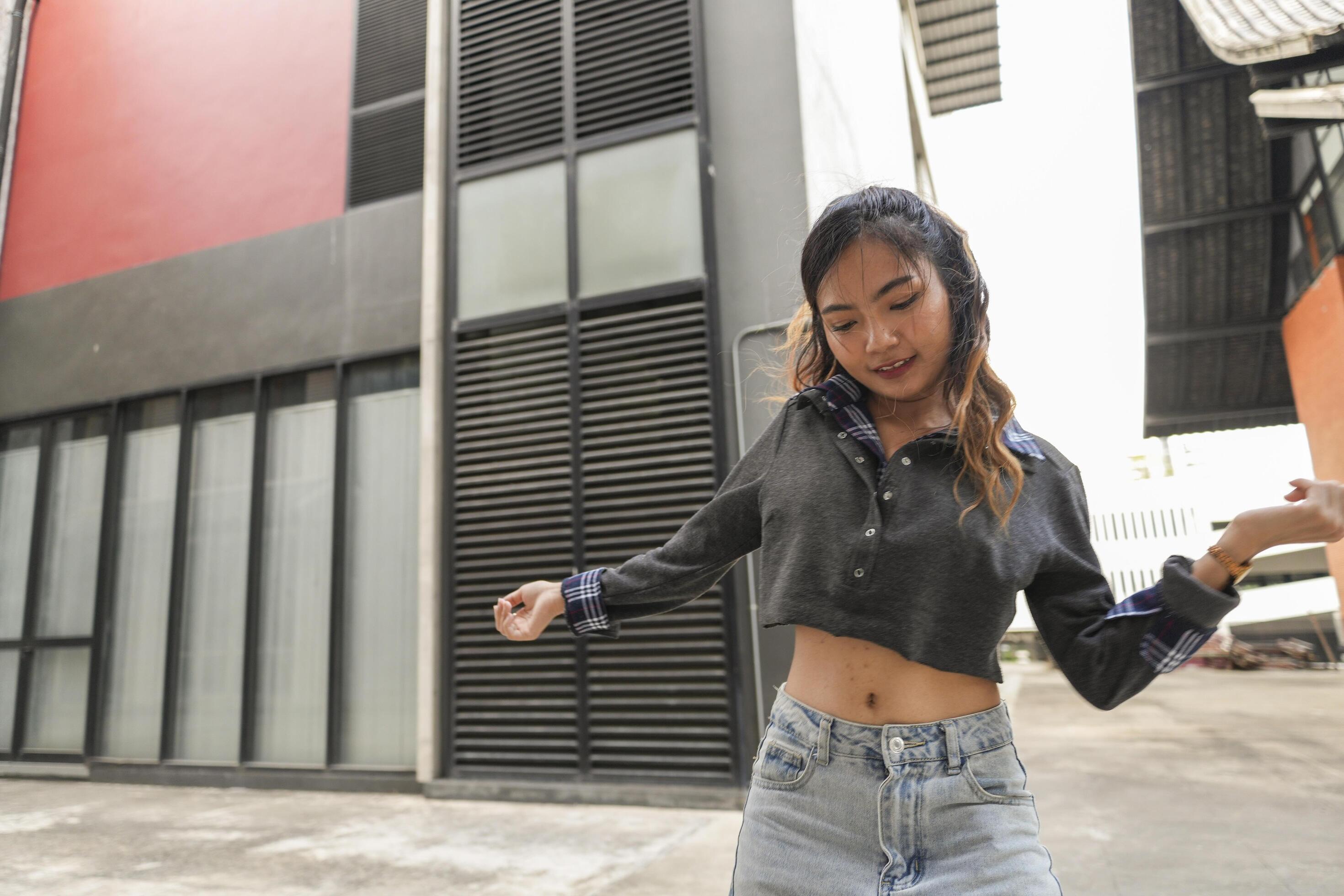 Asian women do freestyle hip hop and breakdancing in a public space in the middle of the city. With a cheerful and happy attitude Stock Free