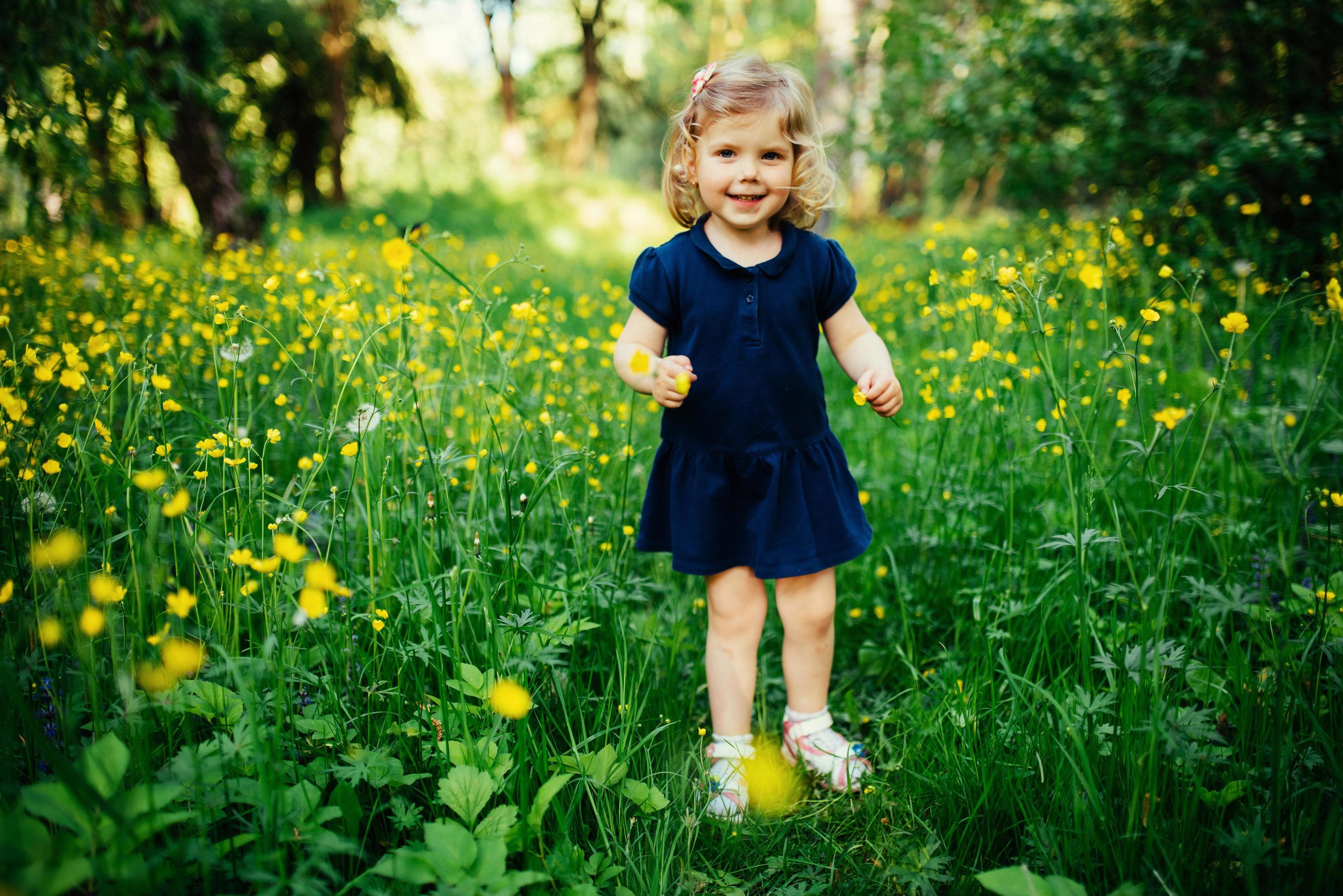 child playing outdoors in the grass Stock Free