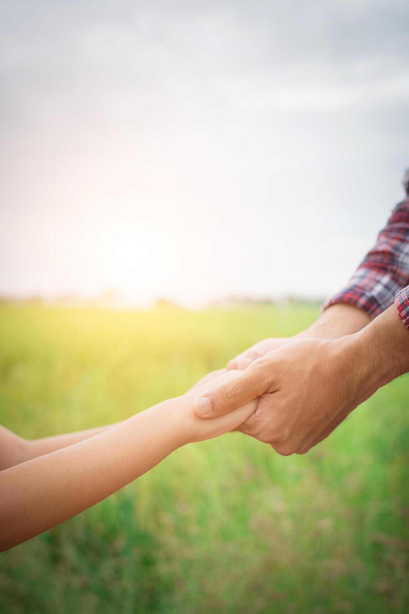 Close up of father holding his daughter hand, so sweet,family time. Stock Free