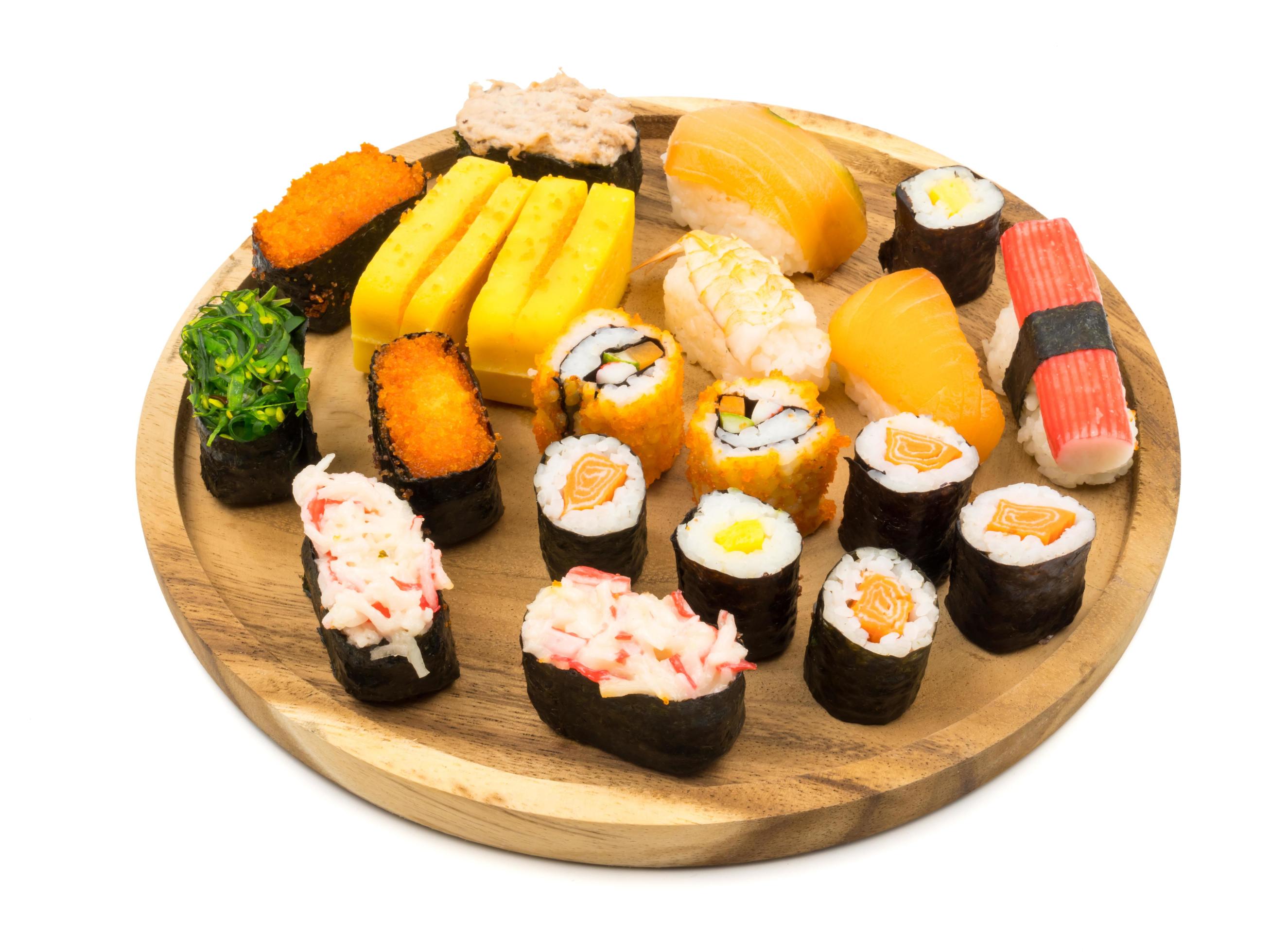 Sushi set on wooden plate on white background, Japanese food. Stock Free