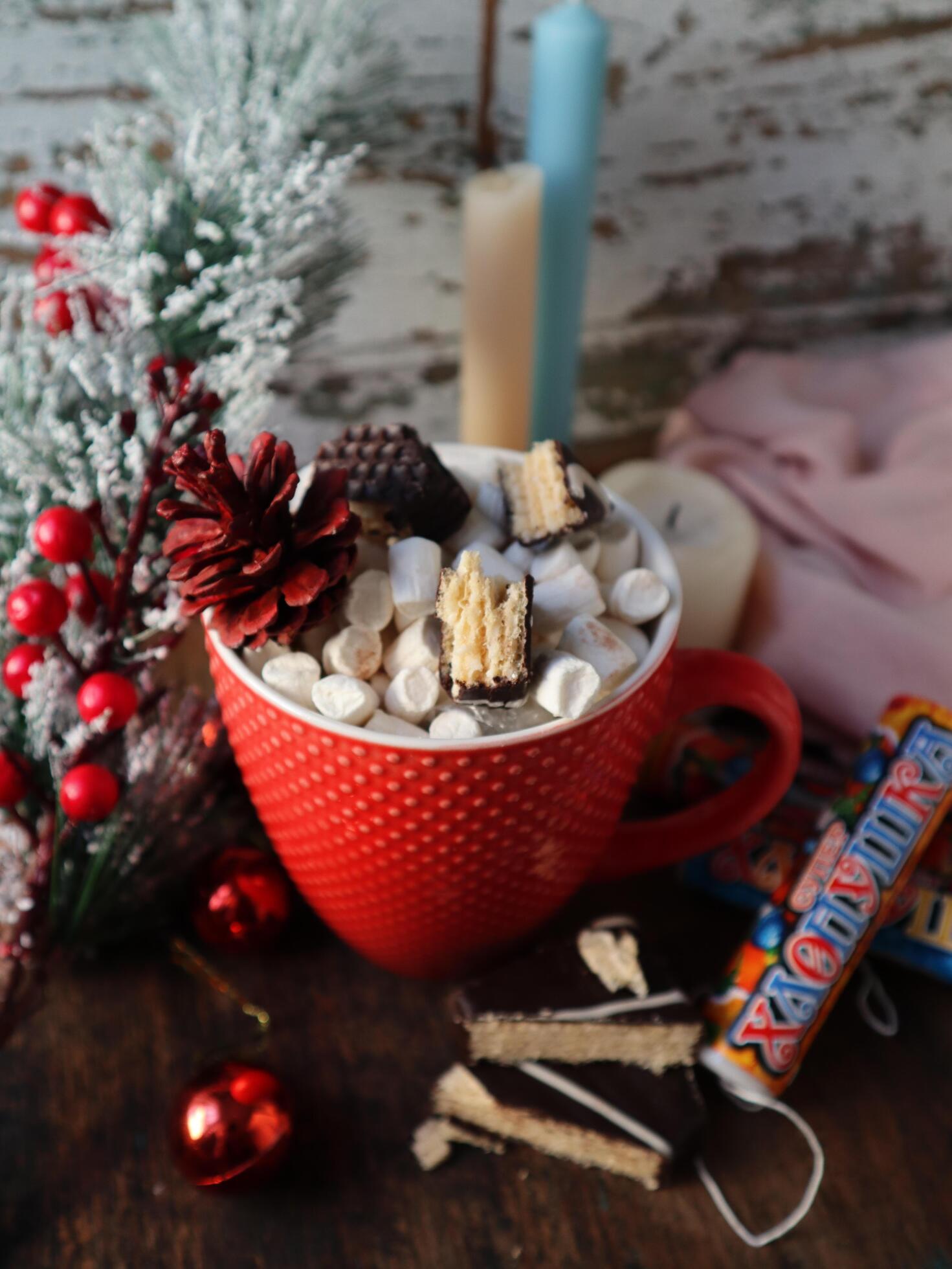 Cup of hot cocoa with marshmallows and cinnamon on a table with christmas decoration Stock Free