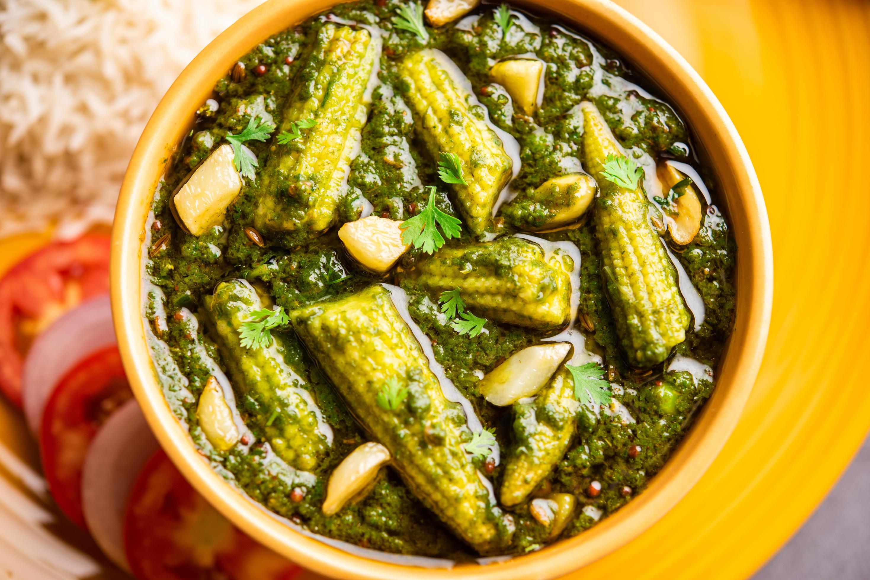 palak baby corn sabzi also known as spinach makai curry served with rice or roti, Indian food Stock Free