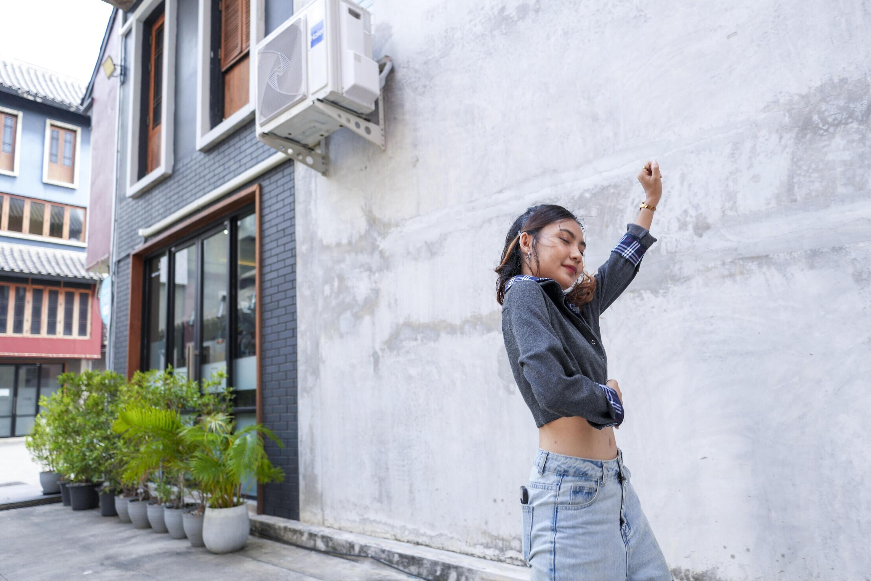 Asian women do freestyle hip hop and breakdancing in a public space in the middle of the city. With a cheerful and happy attitude Stock Free